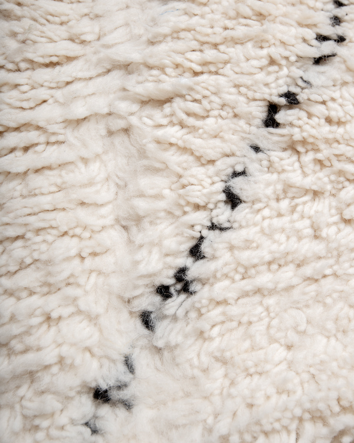 Modern, designer, handcrafted Berber rug from Morocco. Beniourain carpet with minimalist design, natural wool pile and a fluffy texture.