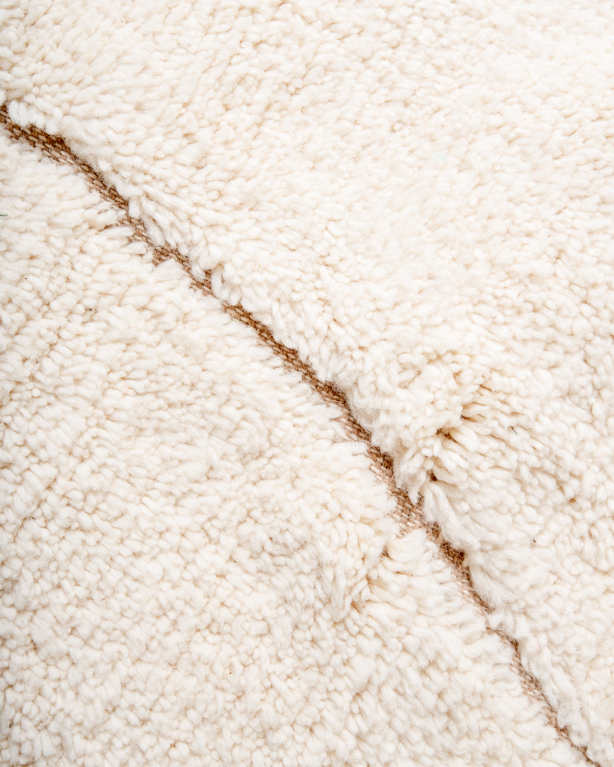 Modern, designer, handcrafted Berber rug from Morocco. Beniourain carpet with minimalist design, natural wool pile and a fluffy texture.