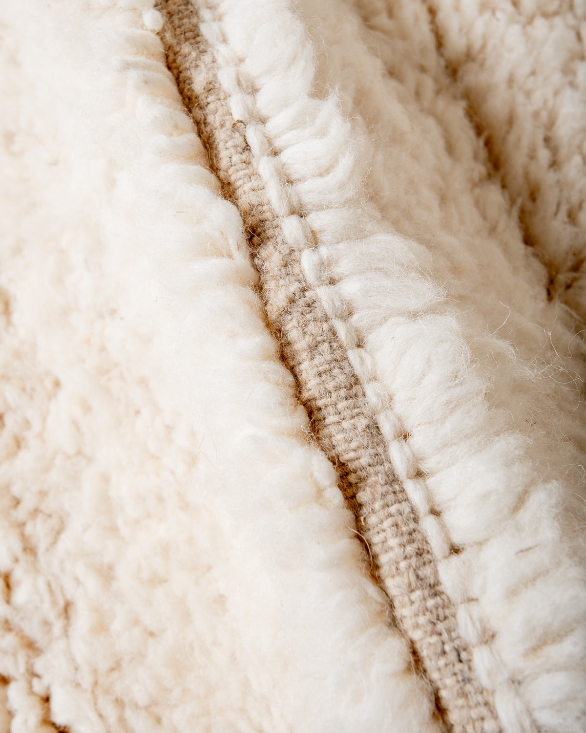 Modern, designer, handcrafted Berber rug from Morocco. Beniourain carpet with minimalist design, natural wool pile and a fluffy texture.