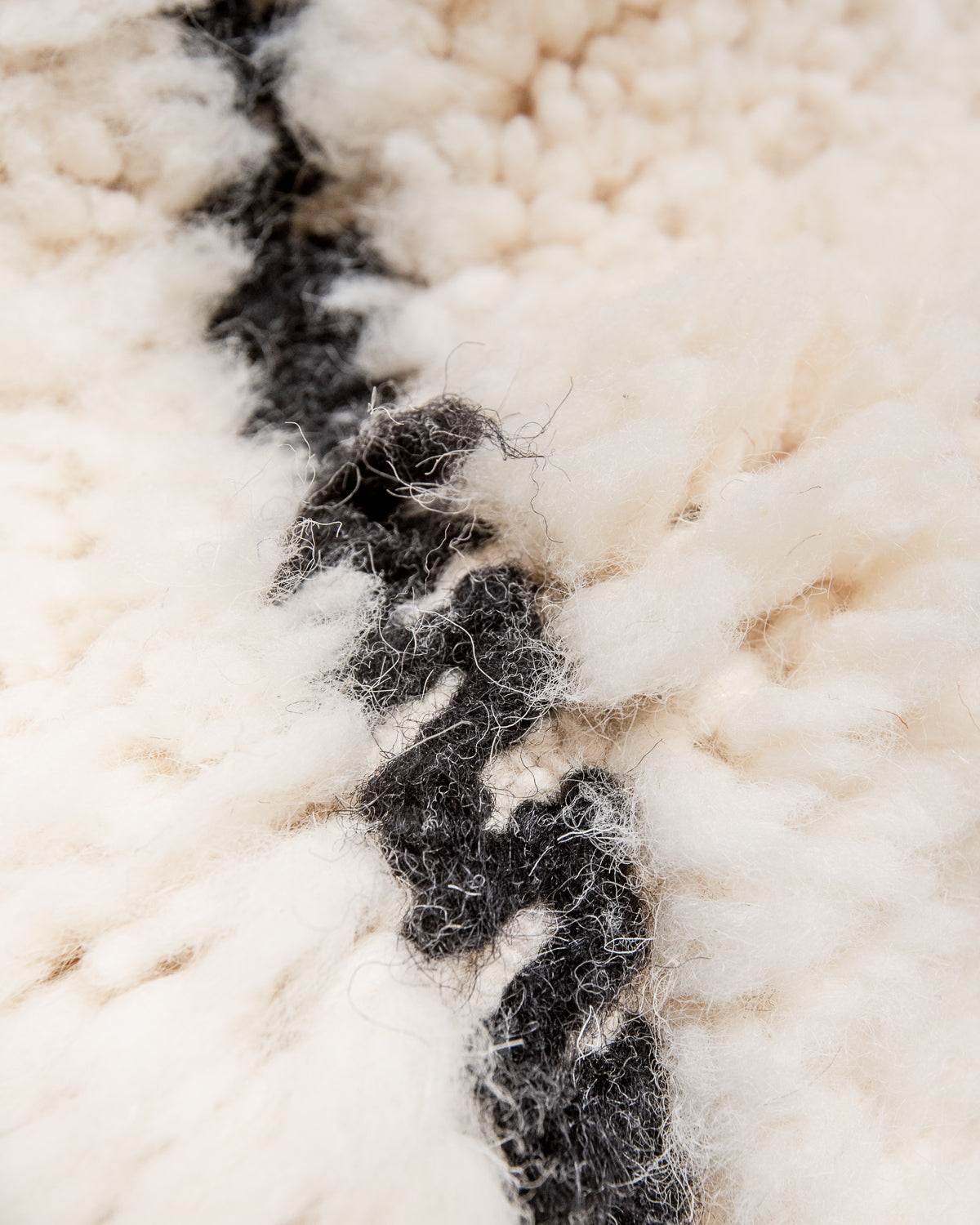 Modern, designer, handcrafted Berber rug from Morocco. Beniourain carpet with minimalist design, natural wool pile and a fluffy texture.