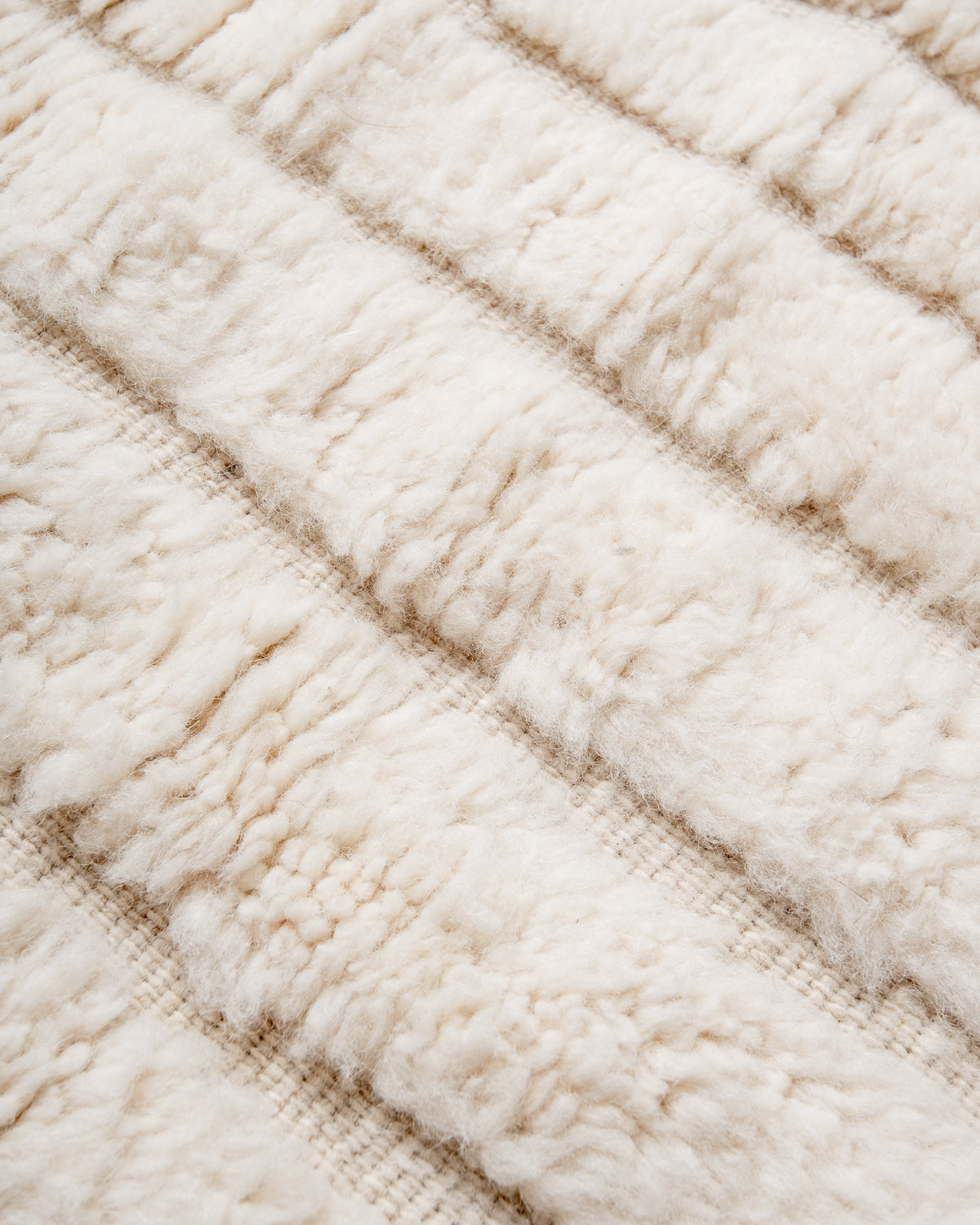 Modern, designer, handcrafted Berber rug from Morocco. Beniourain carpet with minimalist design, natural wool pile and a fluffy texture.