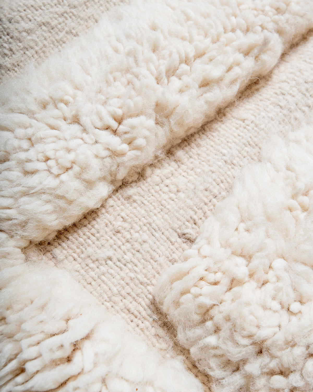 Modern, designer, handcrafted Berber rug from Morocco. Beniourain carpet with minimalist design, natural wool pile and a fluffy texture.