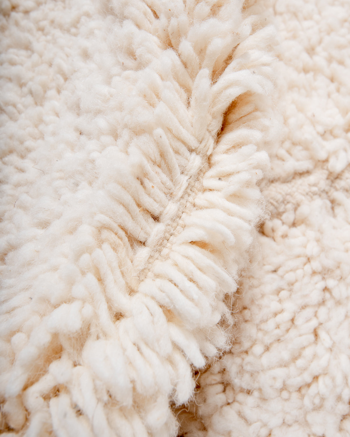 Modern, designer, handcrafted Berber rug from Morocco. Beniourain carpet with minimalist design, natural wool pile and a fluffy texture.