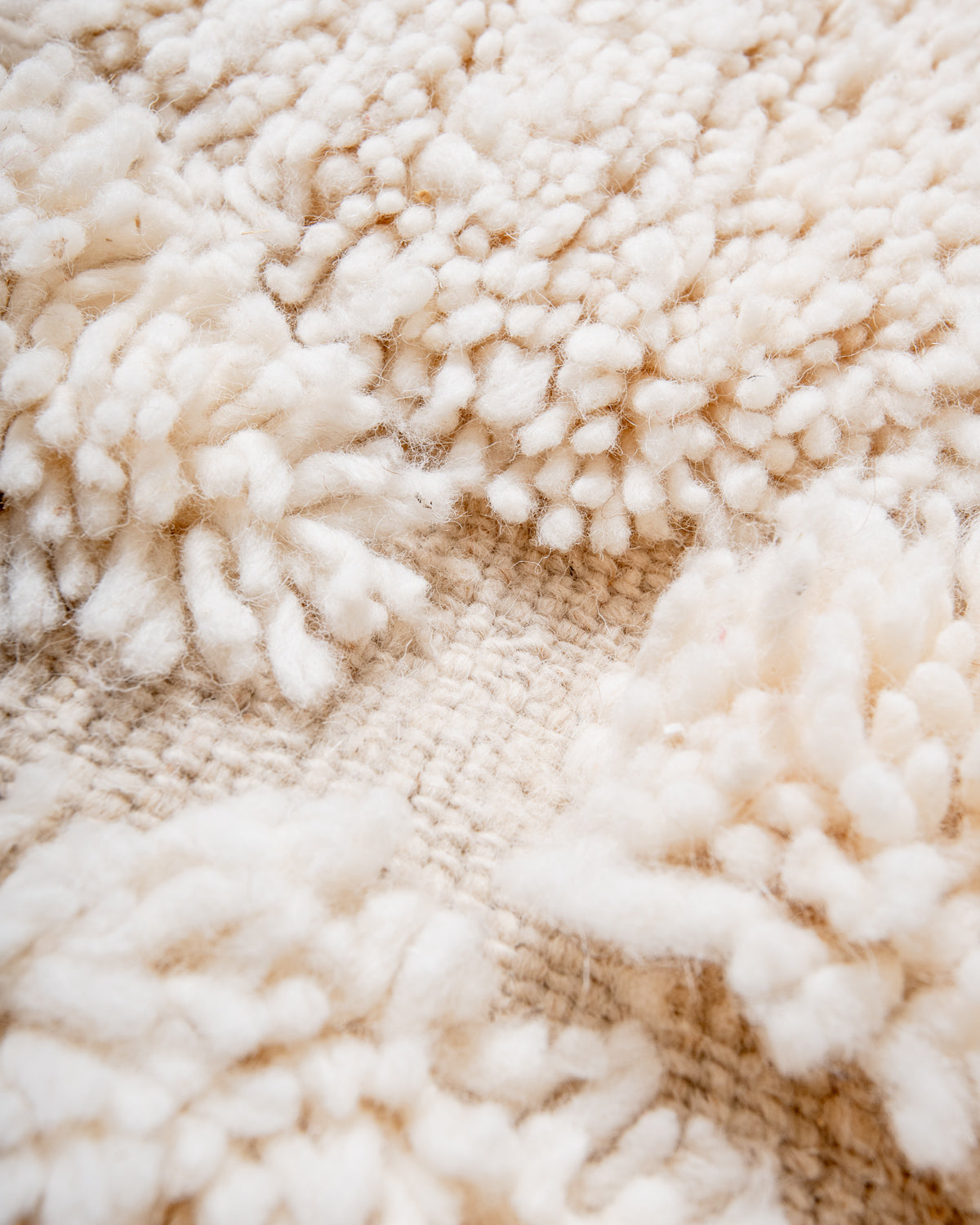 Modern, designer, handcrafted Berber rug from Morocco. Beniourain carpet with minimalist design, natural wool pile and a fluffy texture.