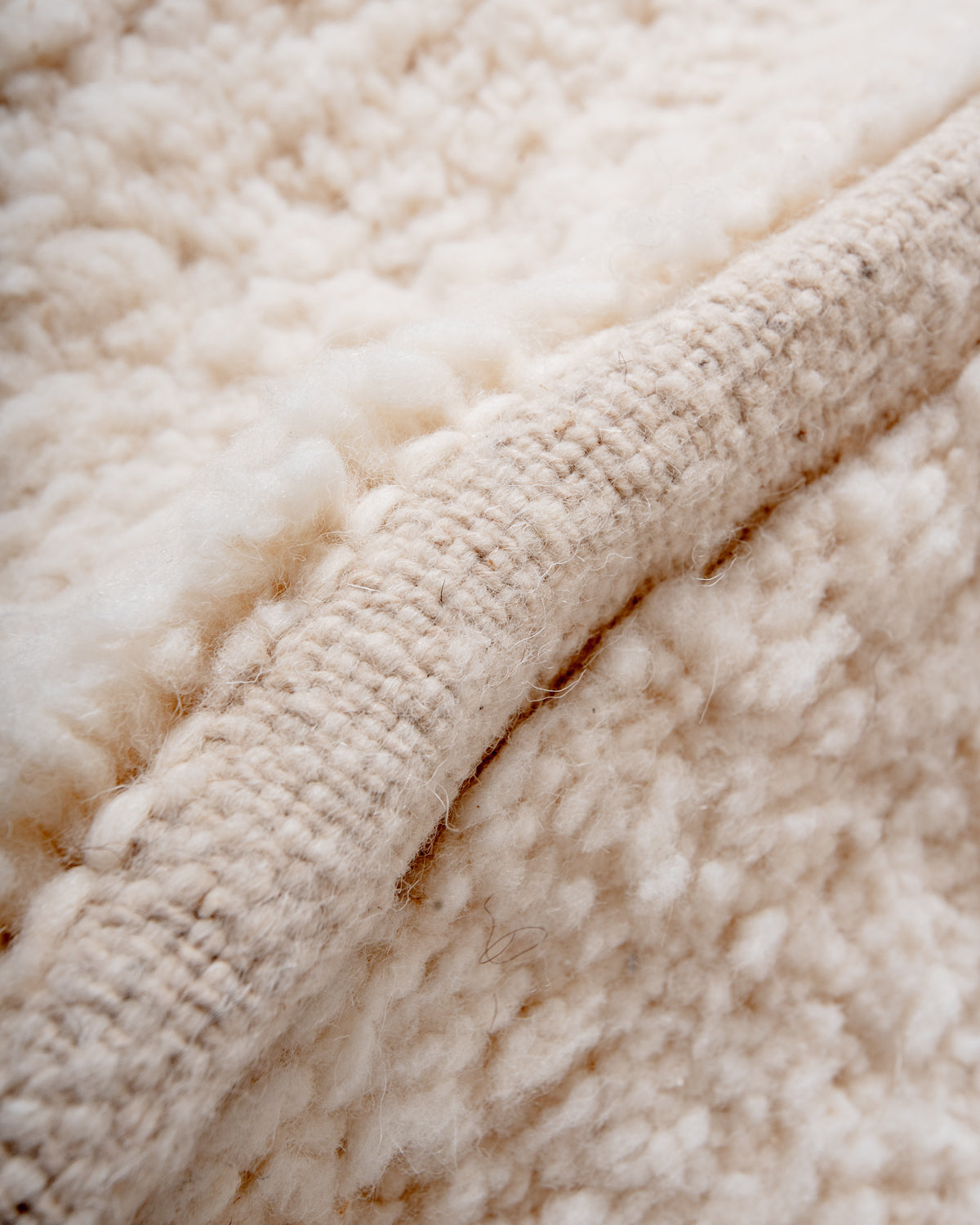 Modern, designer, handcrafted Berber rug from Morocco. Beniourain carpet with minimalist design, natural wool pile and a fluffy texture.