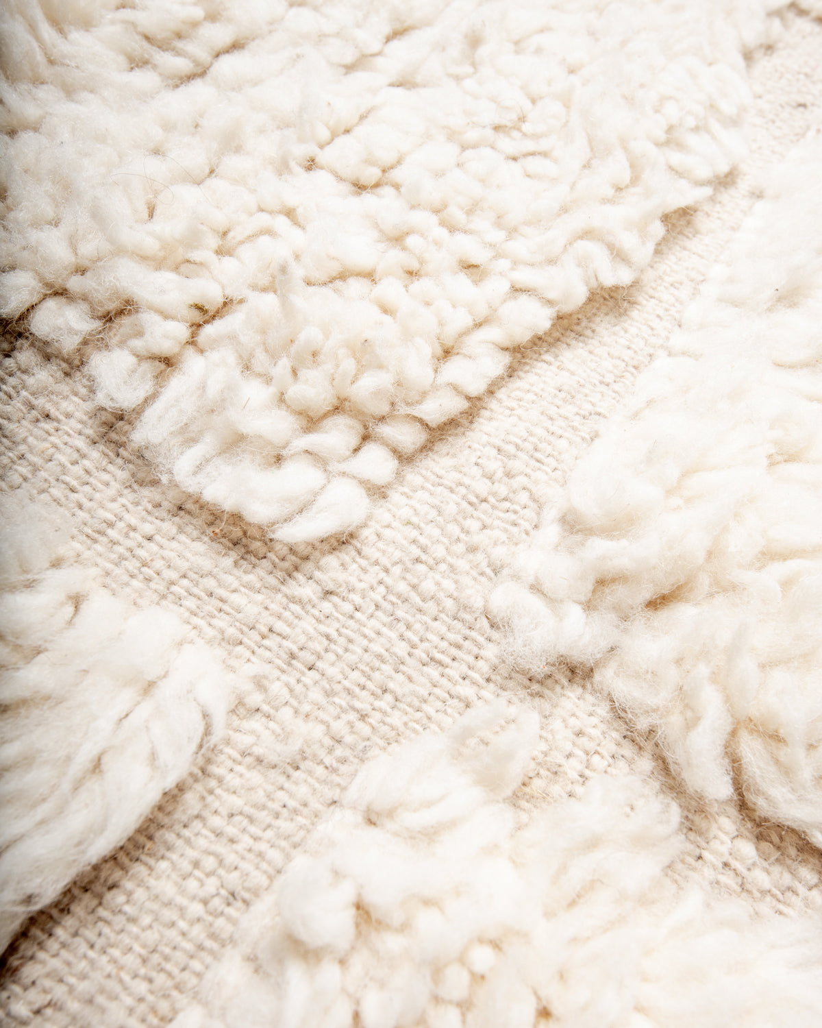 Modern, designer, handcrafted Berber rug from Morocco. Beniourain carpet with minimalist design, natural wool pile and a fluffy texture.