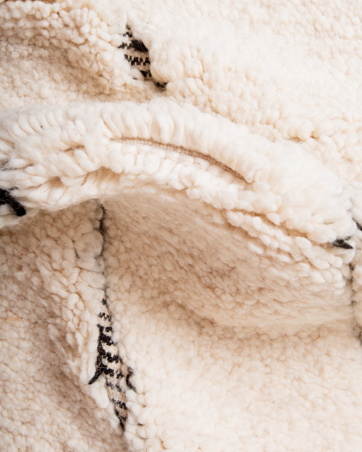 Modern, designer, handcrafted Berber rug from Morocco. Beniourain carpet with minimalist design, natural wool pile and a fluffy texture.