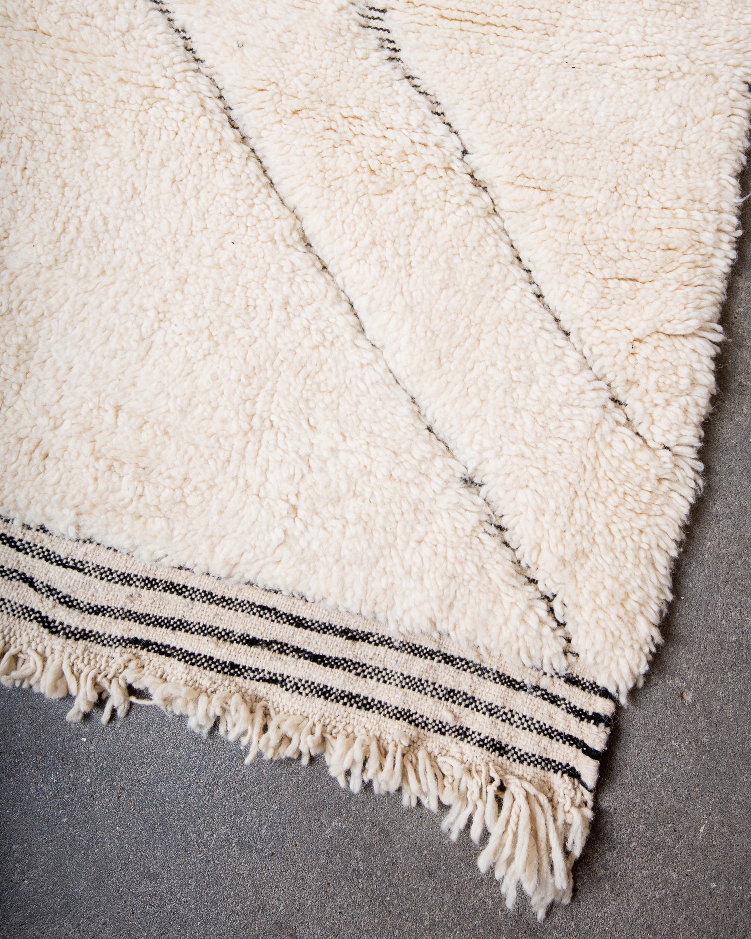 Modern, designer, handcrafted Berber rug from Morocco. Beniourain carpet with minimalist design, natural wool pile and a fluffy texture.