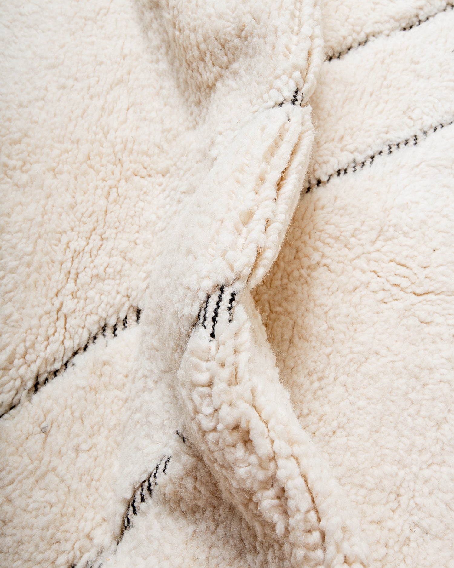 Modern, designer, handcrafted Berber rug from Morocco. Beniourain carpet with minimalist design, natural wool pile and a fluffy texture.