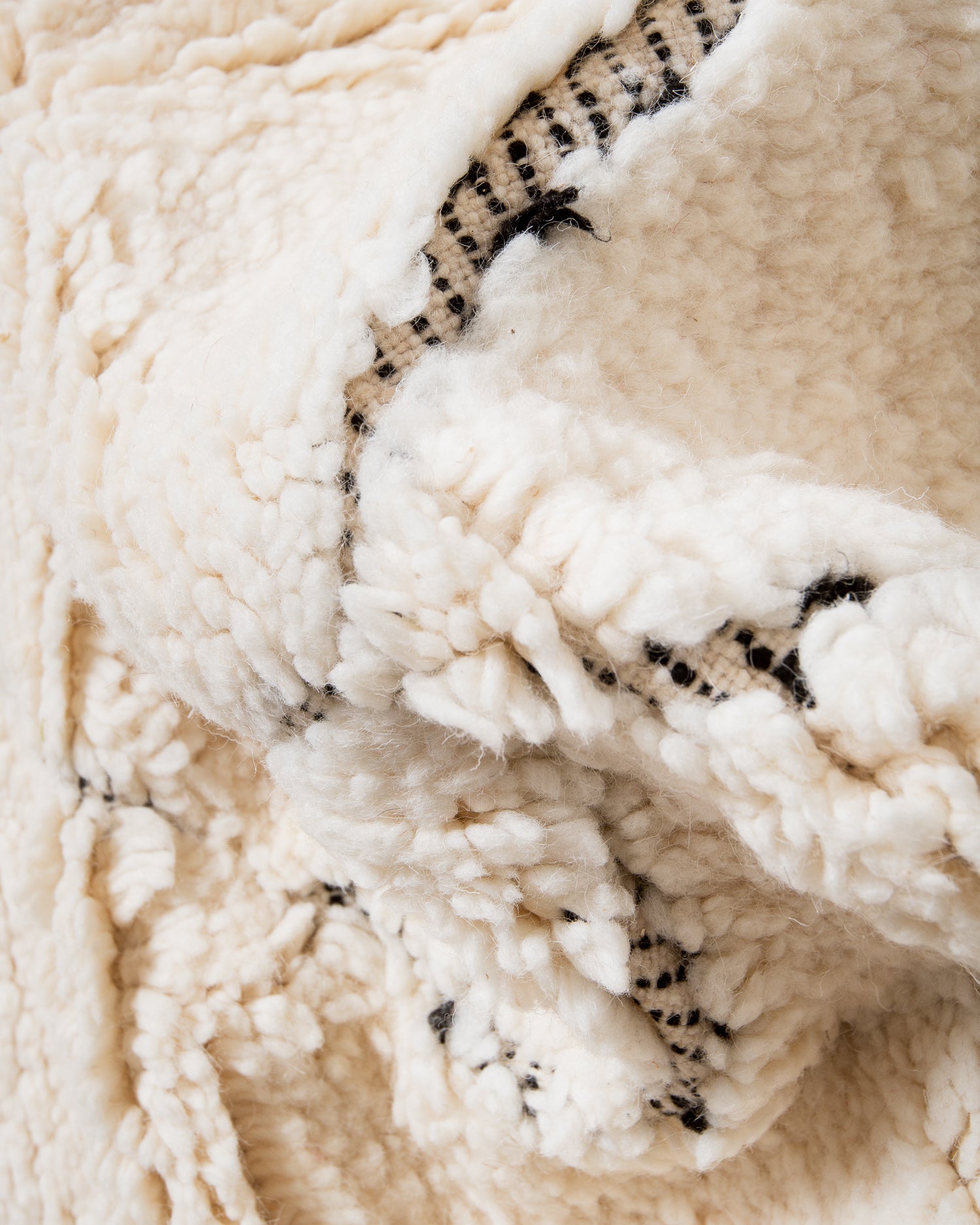 Modern, designer, handcrafted Berber rug from Morocco. Beniourain carpet with minimalist design, natural wool pile and a fluffy texture.