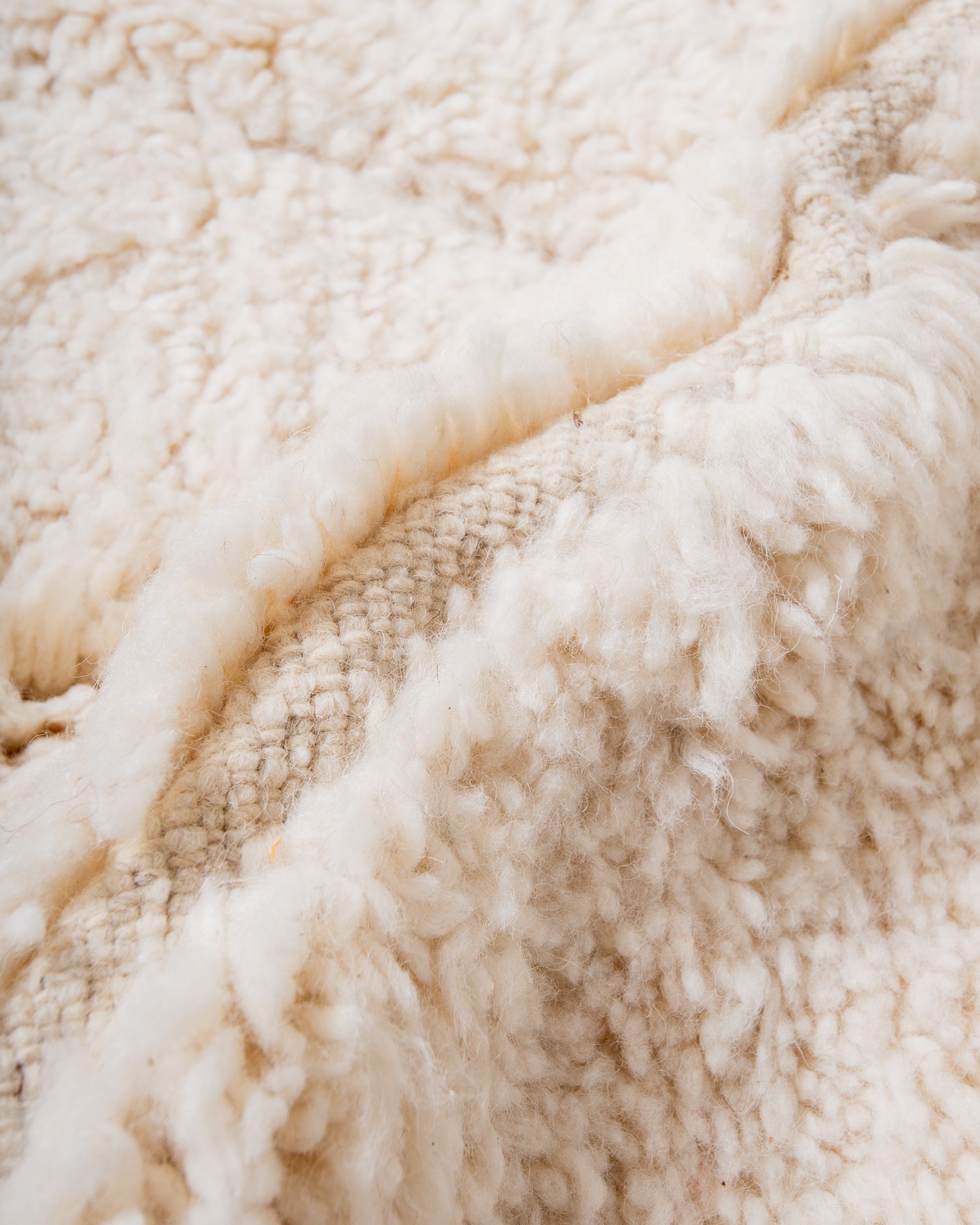 Modern, designer, handcrafted Berber rug from Morocco. Beniourain carpet with minimalist design, natural wool pile and a fluffy texture.