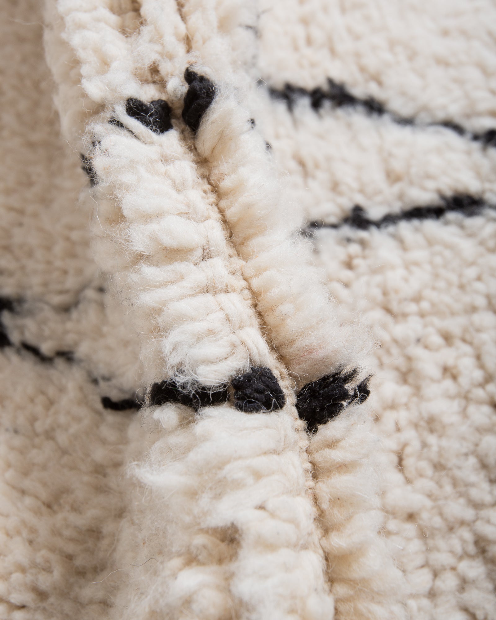 Modern, designer, handcrafted Berber rug from Morocco. Beniourain carpet with minimalist design, natural wool pile and a fluffy texture.