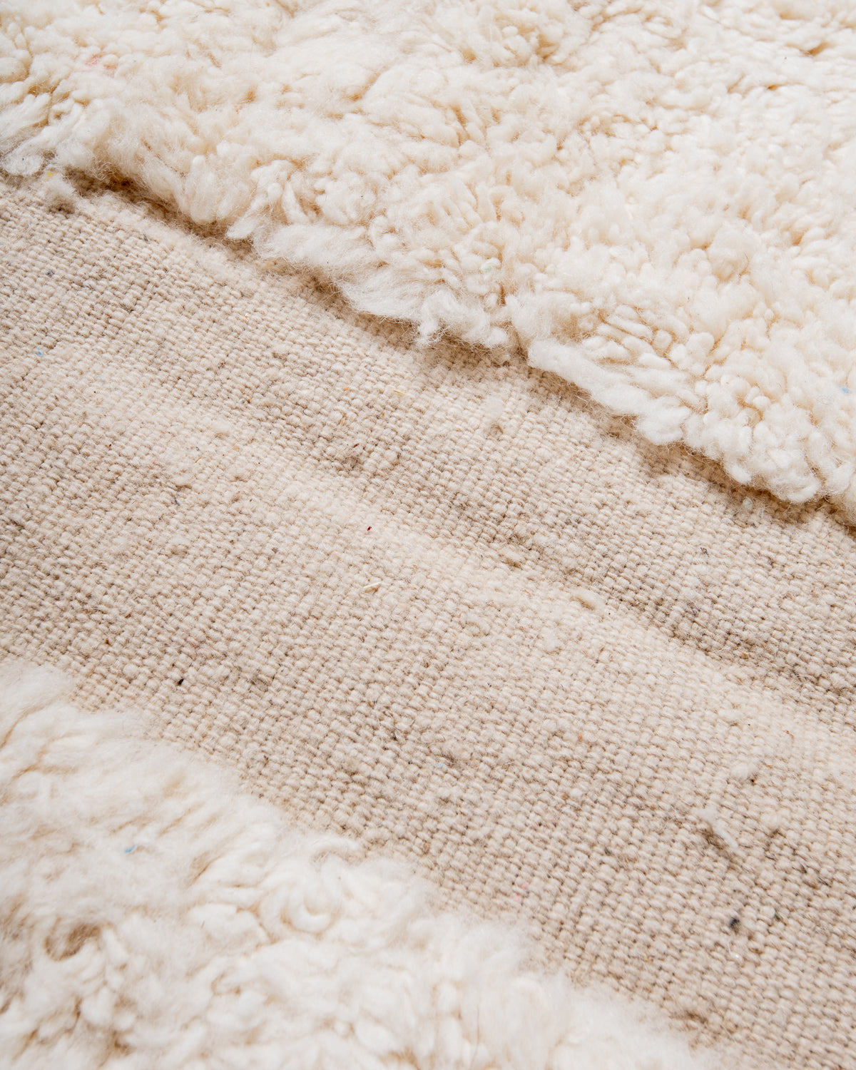 Modern, designer, handcrafted Berber rug from Morocco. Beniourain carpet with minimalist design, natural wool pile and a fluffy texture.
