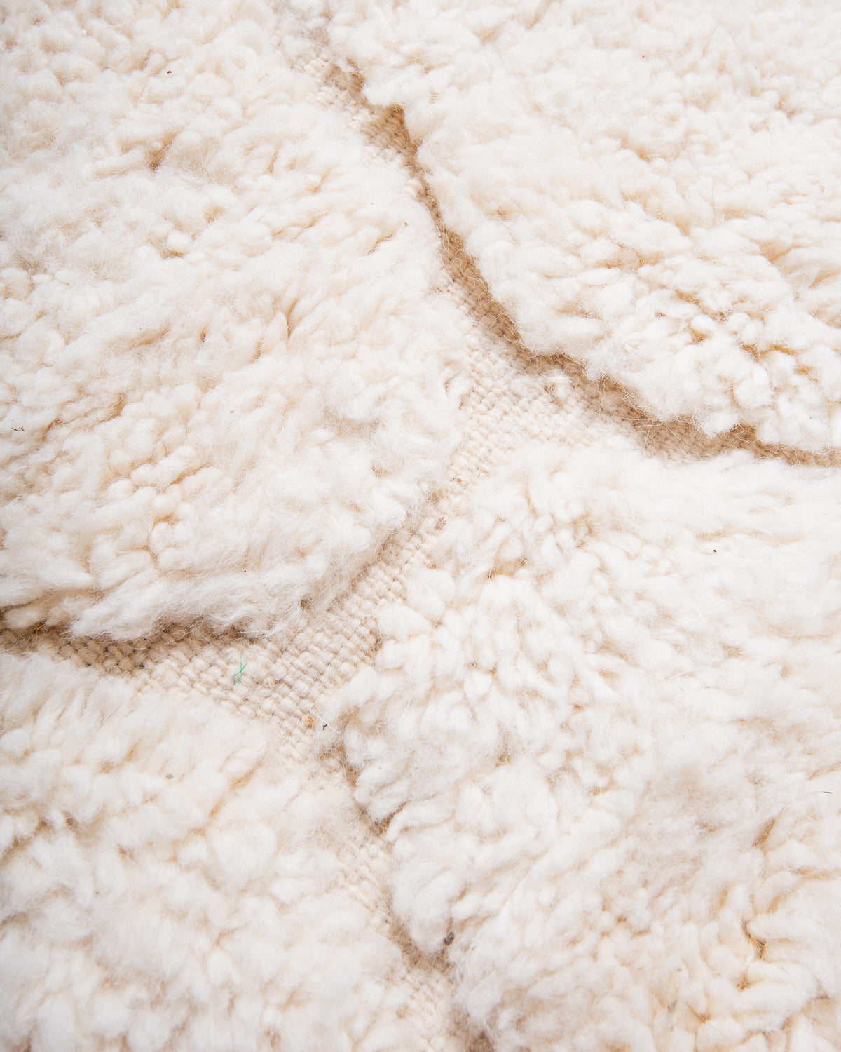 Modern, designer, handcrafted Berber rug from Morocco. Beniourain carpet with minimalist design, natural wool pile and a fluffy texture.