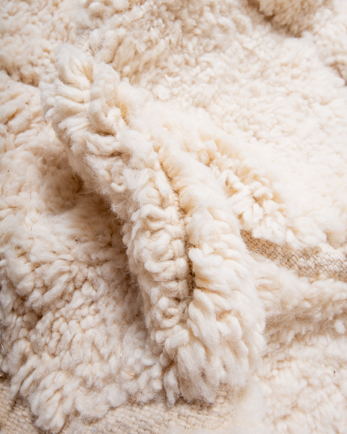 Modern, designer, handcrafted Berber rug from Morocco. Beniourain carpet with minimalist design, natural wool pile and a fluffy texture.