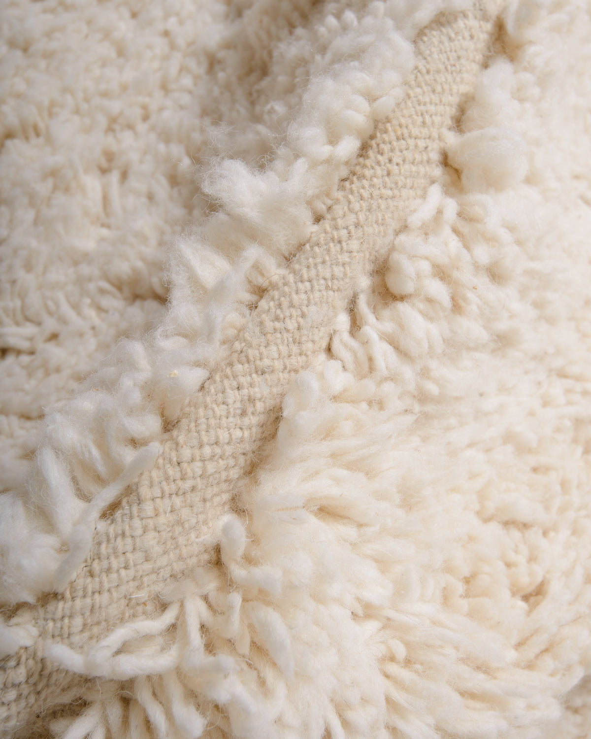 Modern, designer, handcrafted Berber rug from Morocco. Beniourain carpet with minimalist design, natural wool pile and a fluffy texture.