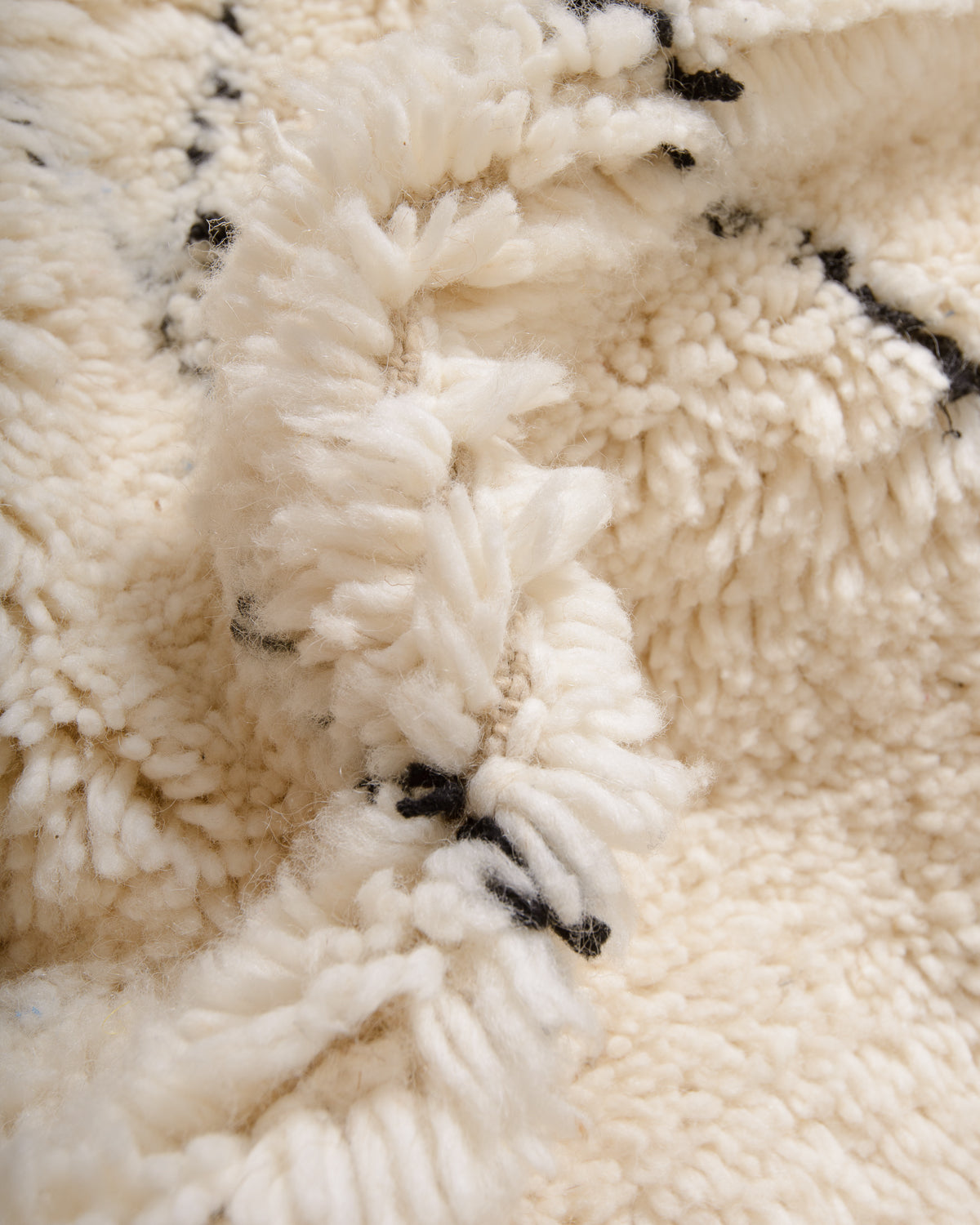 Modern, designer, handcrafted Berber rug from Morocco. Beniourain carpet with minimalist design, natural wool pile and a fluffy texture.