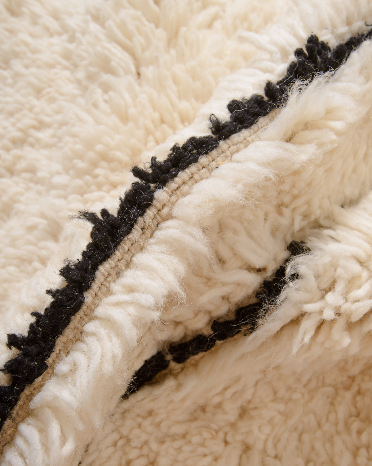 Modern, designer, handcrafted Berber rug from Morocco. Beniourain carpet with minimalist design, natural wool pile and a fluffy texture.