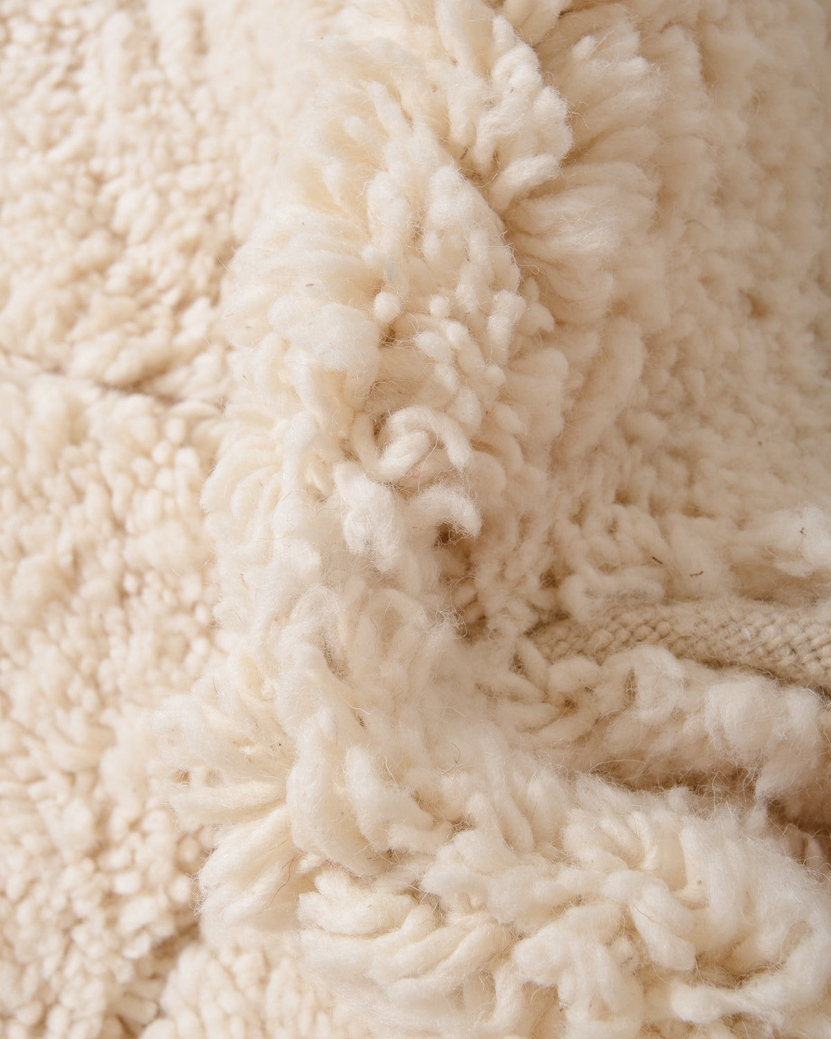 Modern, designer, handcrafted Berber rug from Morocco. Beniourain carpet with minimalist design, natural wool pile and a fluffy texture.