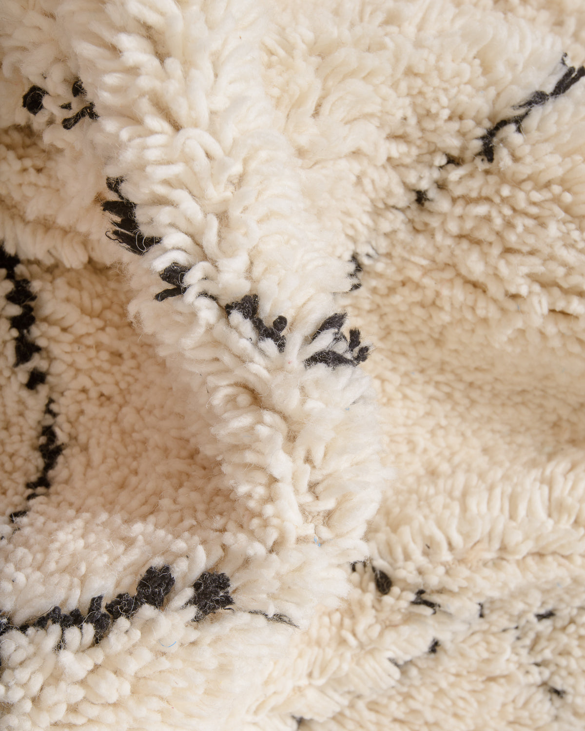 Modern, designer, handcrafted Berber rug from Morocco. Beniourain carpet with minimalist design, natural wool pile and a fluffy texture.