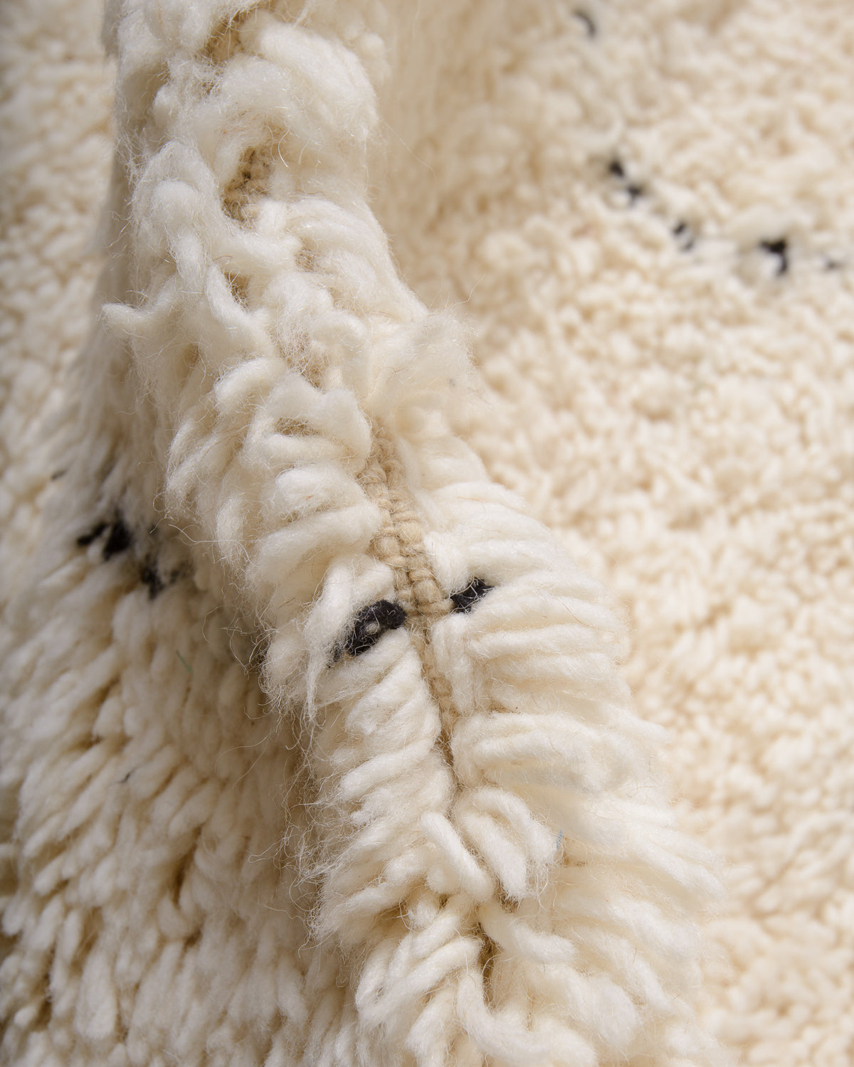 Modern, designer, handcrafted Berber rug from Morocco. Beniourain carpet with minimalist design, natural wool pile and a fluffy texture.