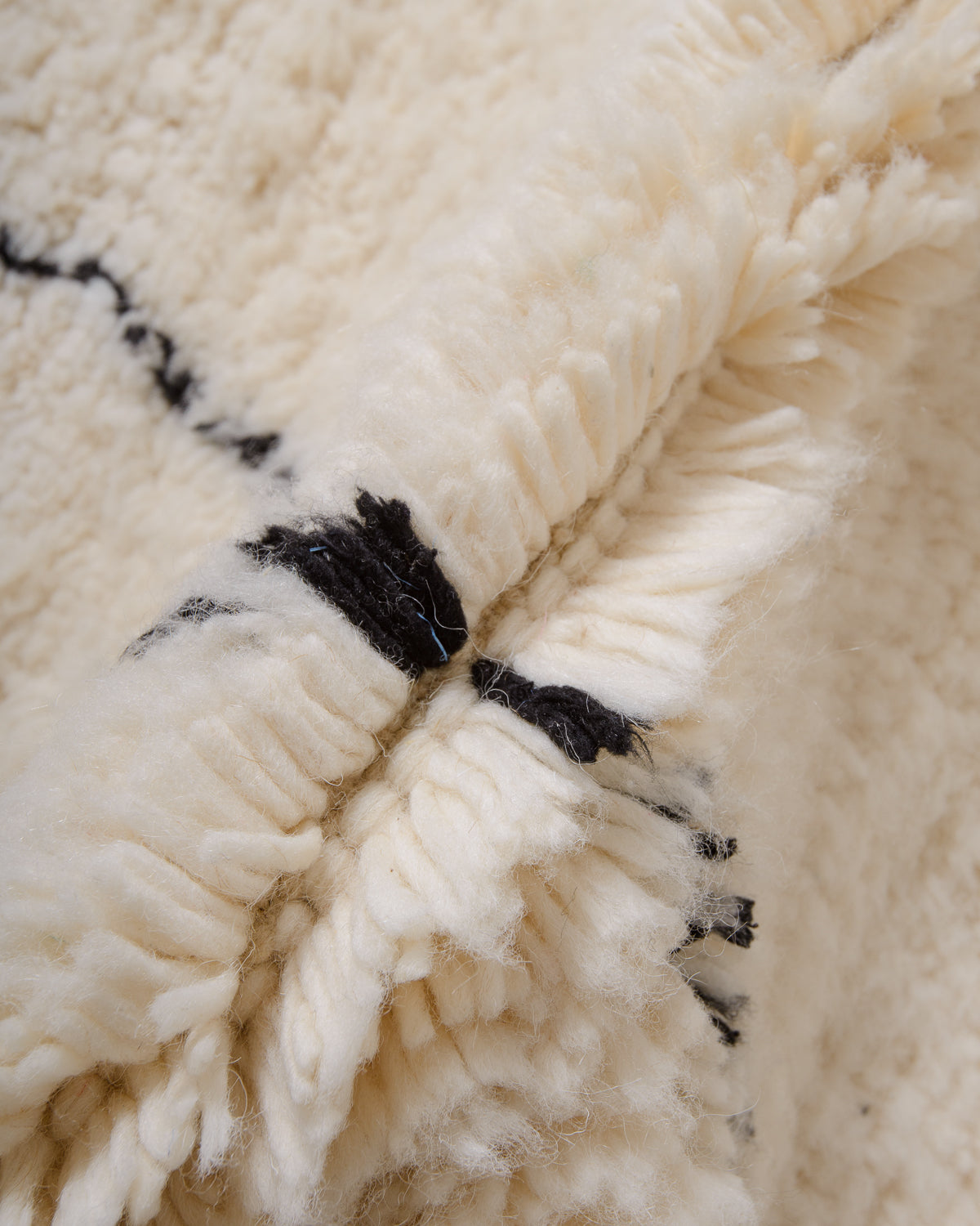 Modern, designer, handcrafted Berber rug from Morocco. Beniourain carpet with minimalist design, natural wool pile and a fluffy texture.