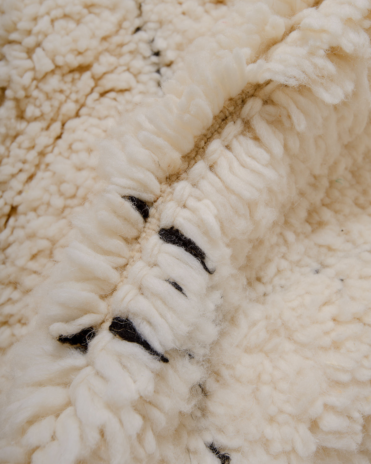 Modern, designer, handcrafted Berber rug from Morocco. Beniourain carpet with minimalist design, natural wool pile and a fluffy texture.