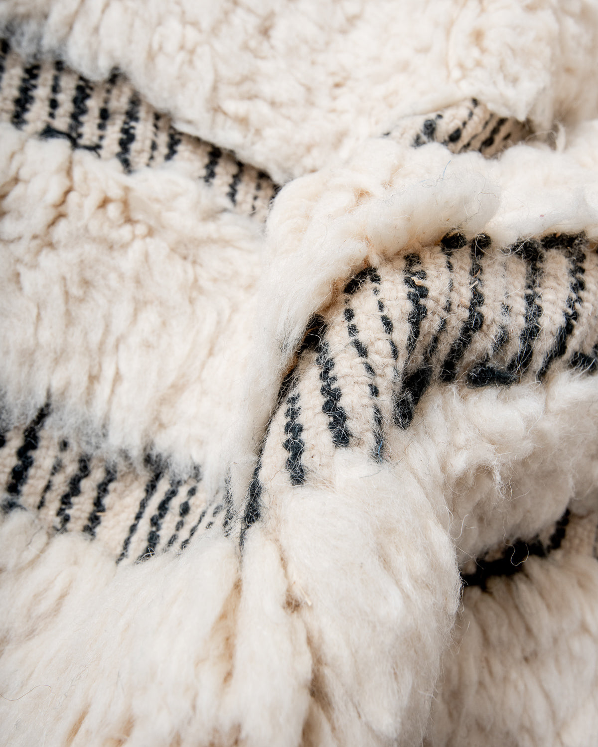 Modern, designer, handcrafted Berber rug from Morocco. Beniourain carpet with minimalist design, natural wool pile and a fluffy texture.