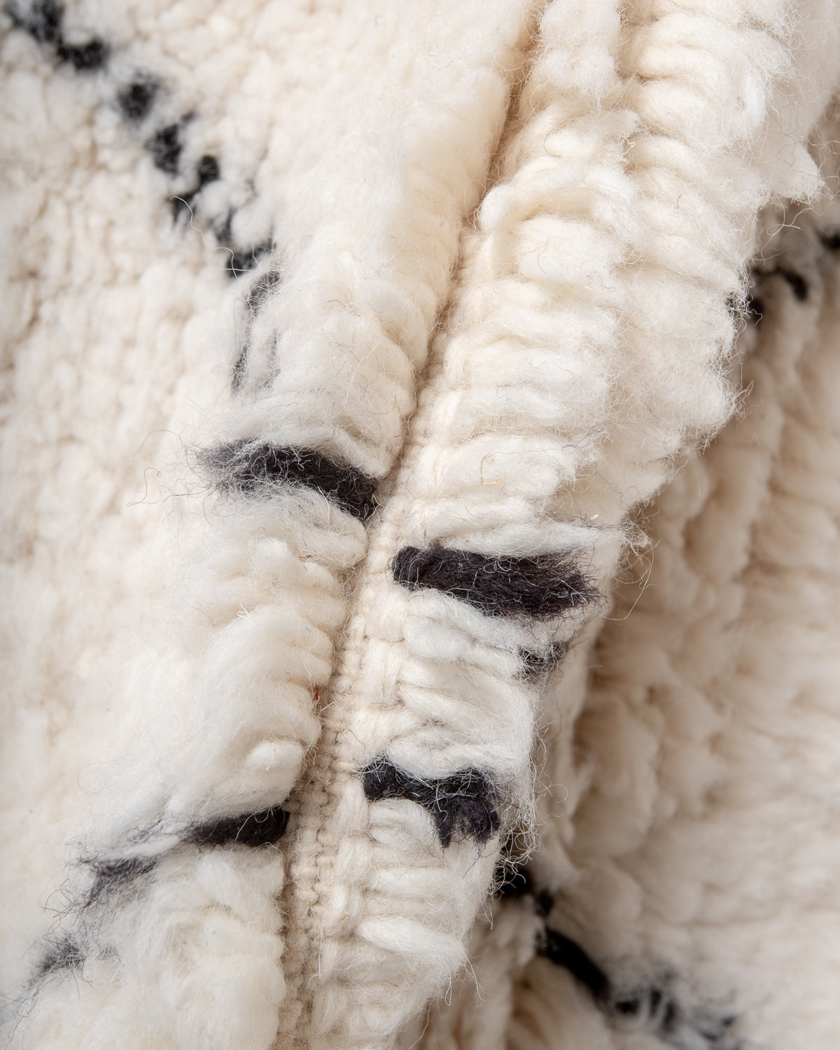 Modern, designer, handcrafted Berber rug from Morocco. Beniourain carpet with minimalist design, natural wool pile and a fluffy texture.