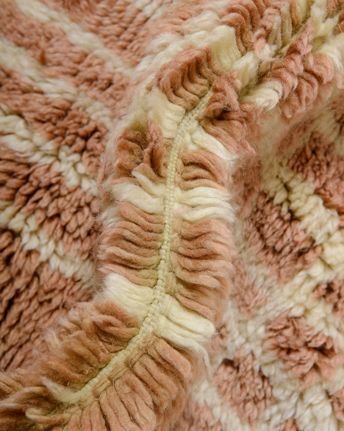 Detail of wool pile in fluffy camel brown and lemon cream.