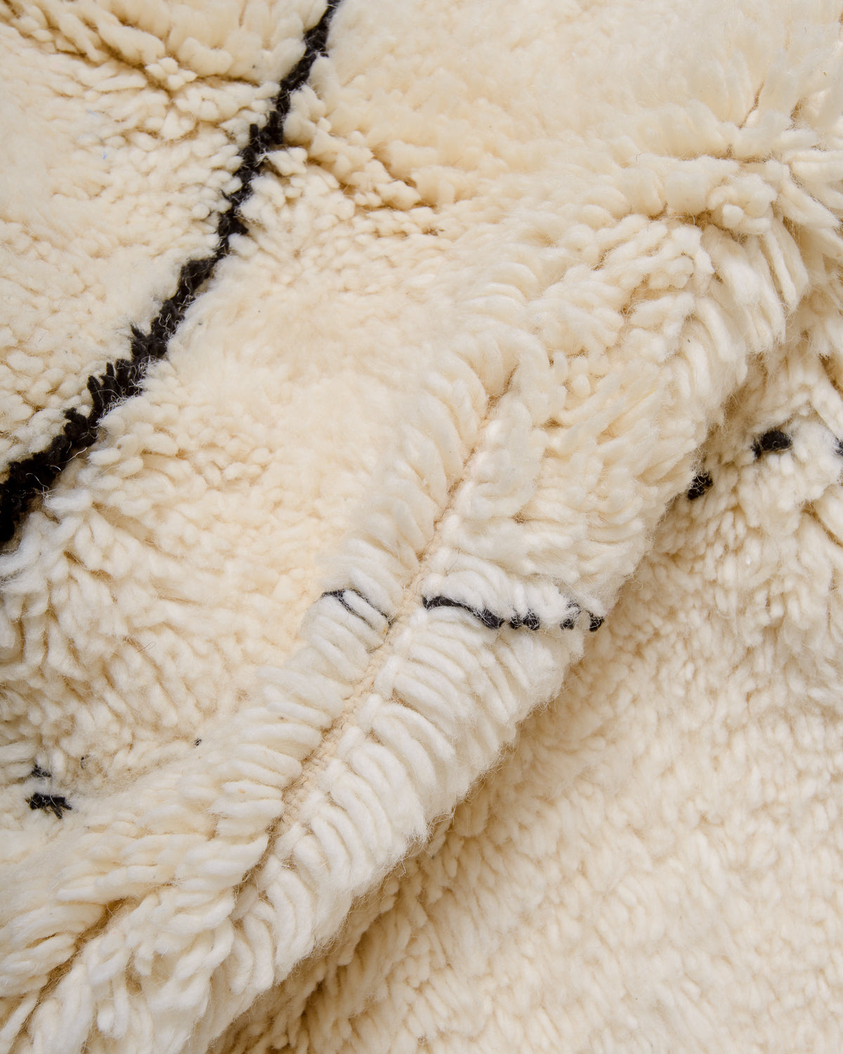 Modern, designer, handcrafted Berber rug from Morocco. Beniourain carpet with minimalist design, natural wool pile and a fluffy texture.