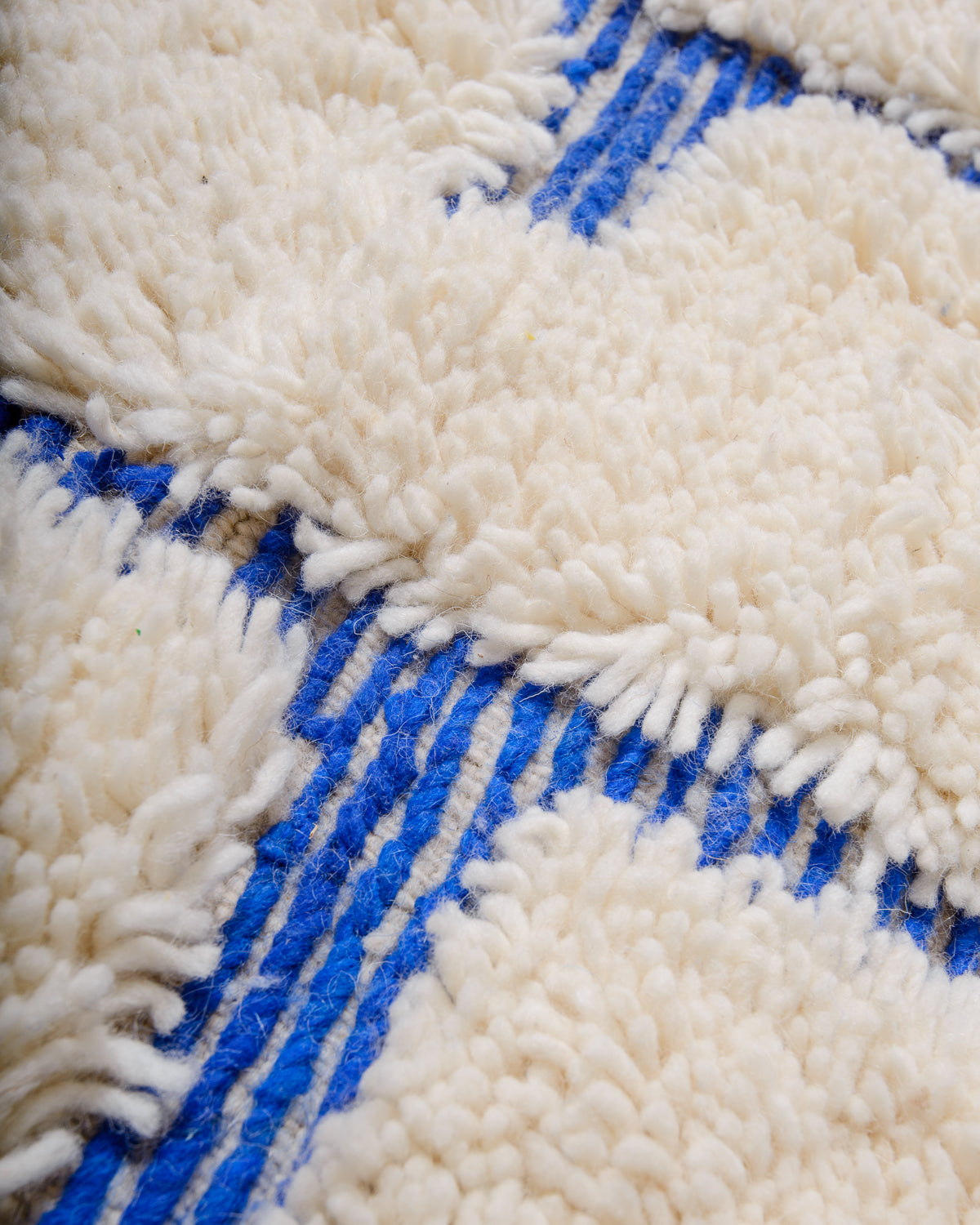 Modern, designer, handcrafted Berber rug from Morocco. Beniourain carpet with minimalist design, natural wool pile and a fluffy texture.