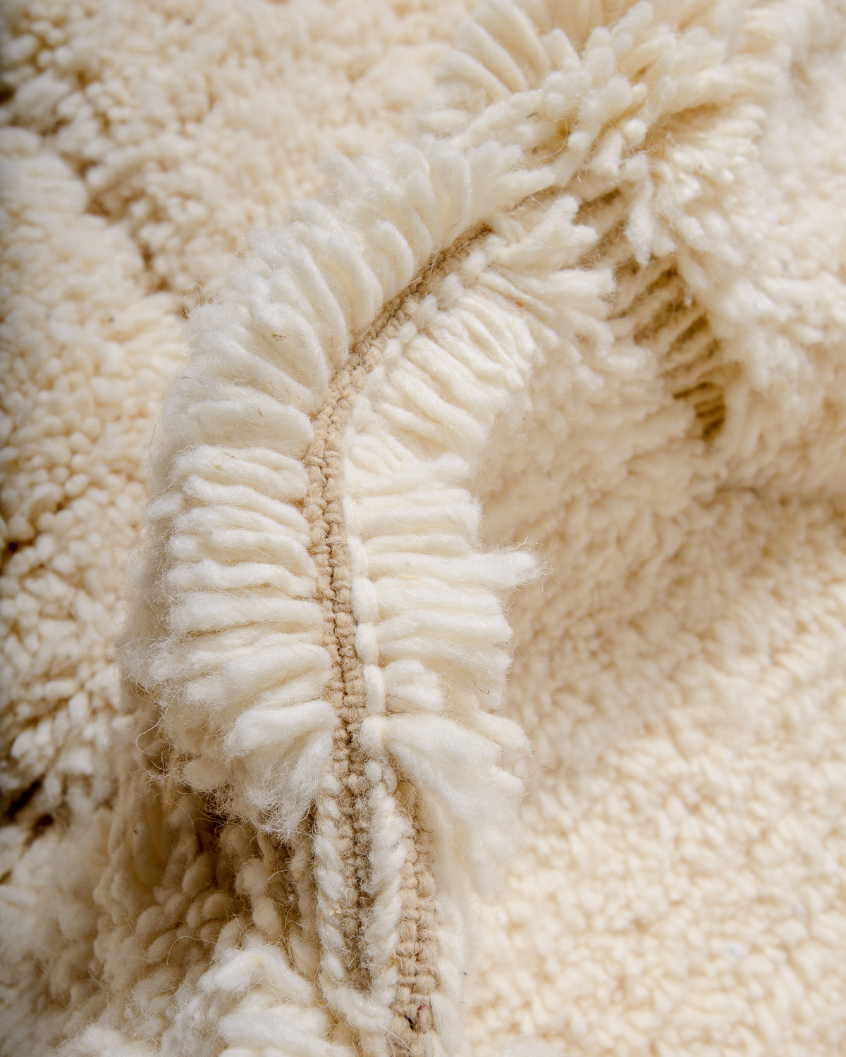 Modern, designer, handcrafted Berber rug from Morocco. Beniourain carpet with minimalist design, natural wool pile and a fluffy texture.