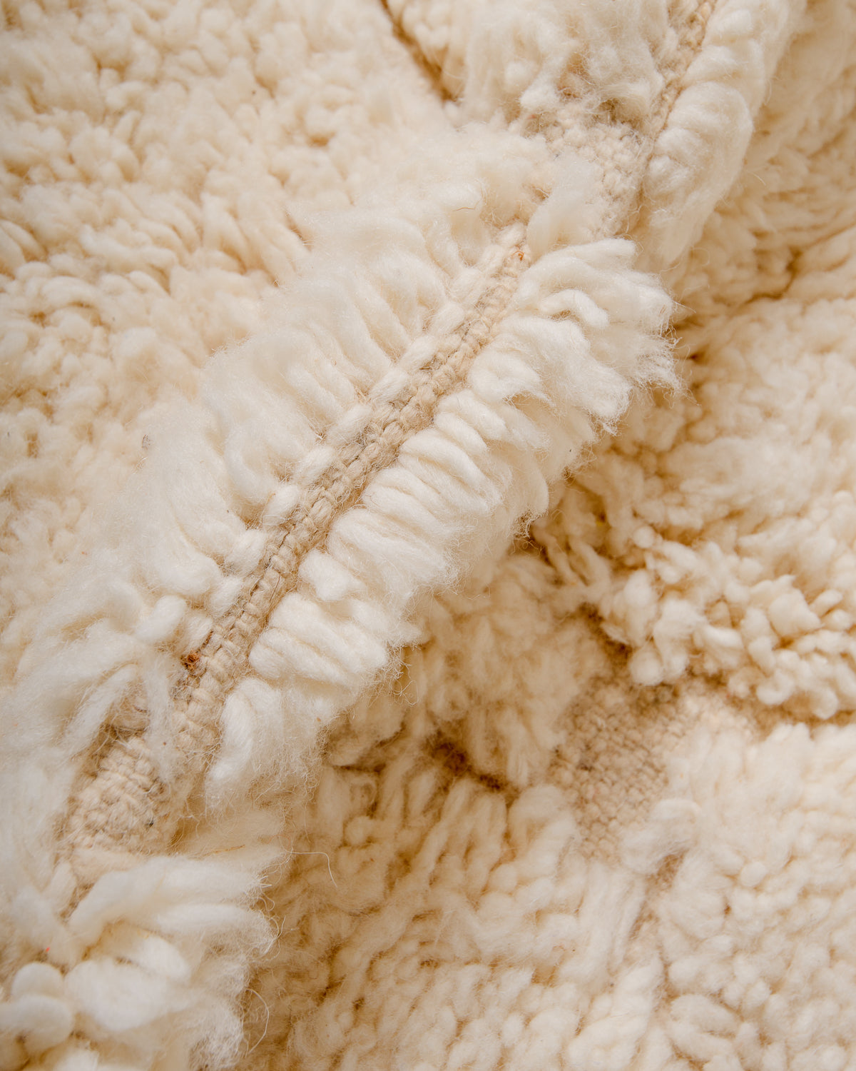 Detail of wool pile of Beniourain rug in natural cream.
