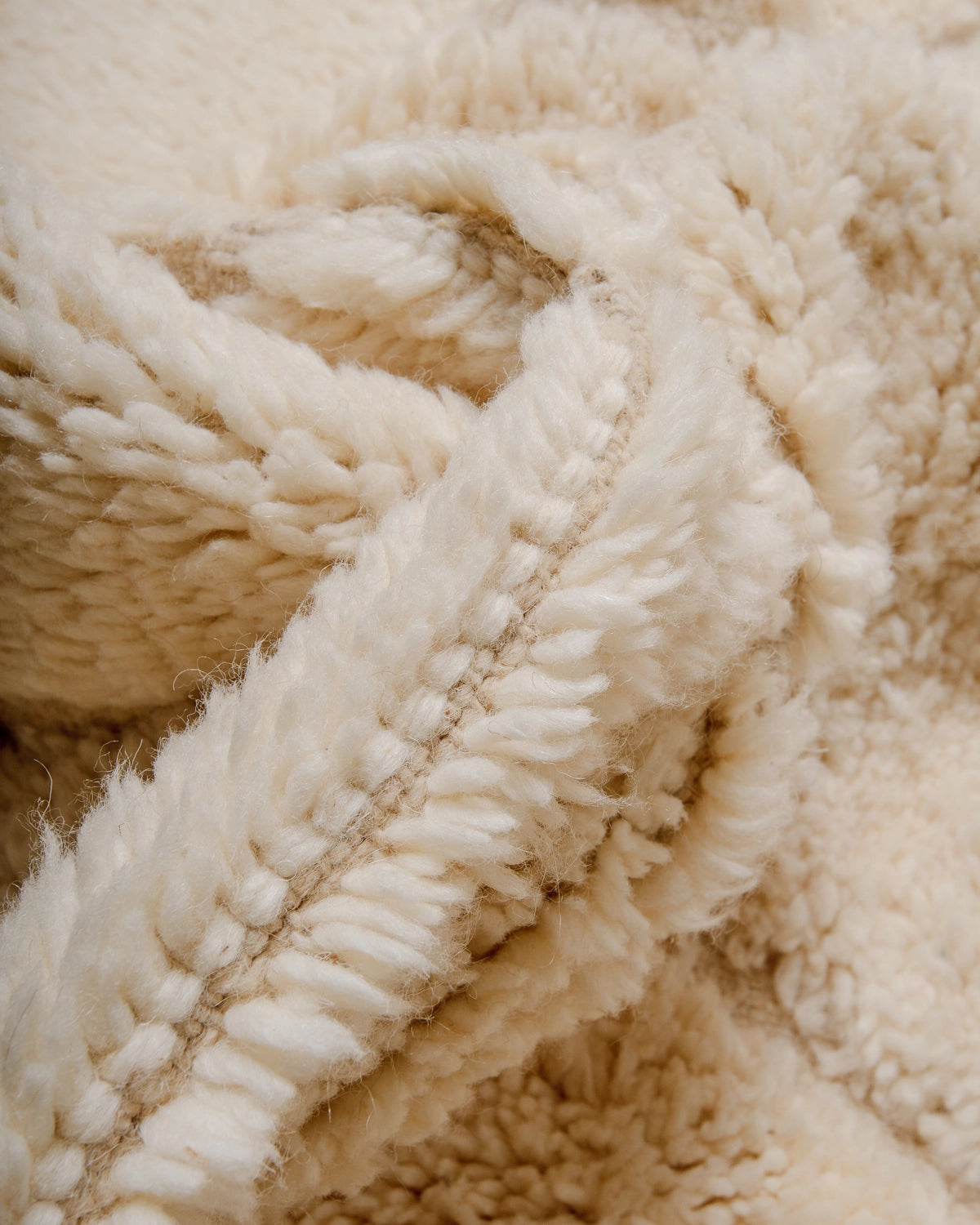Detail of Berberlin Beniourain Rug made of natural cream wool.