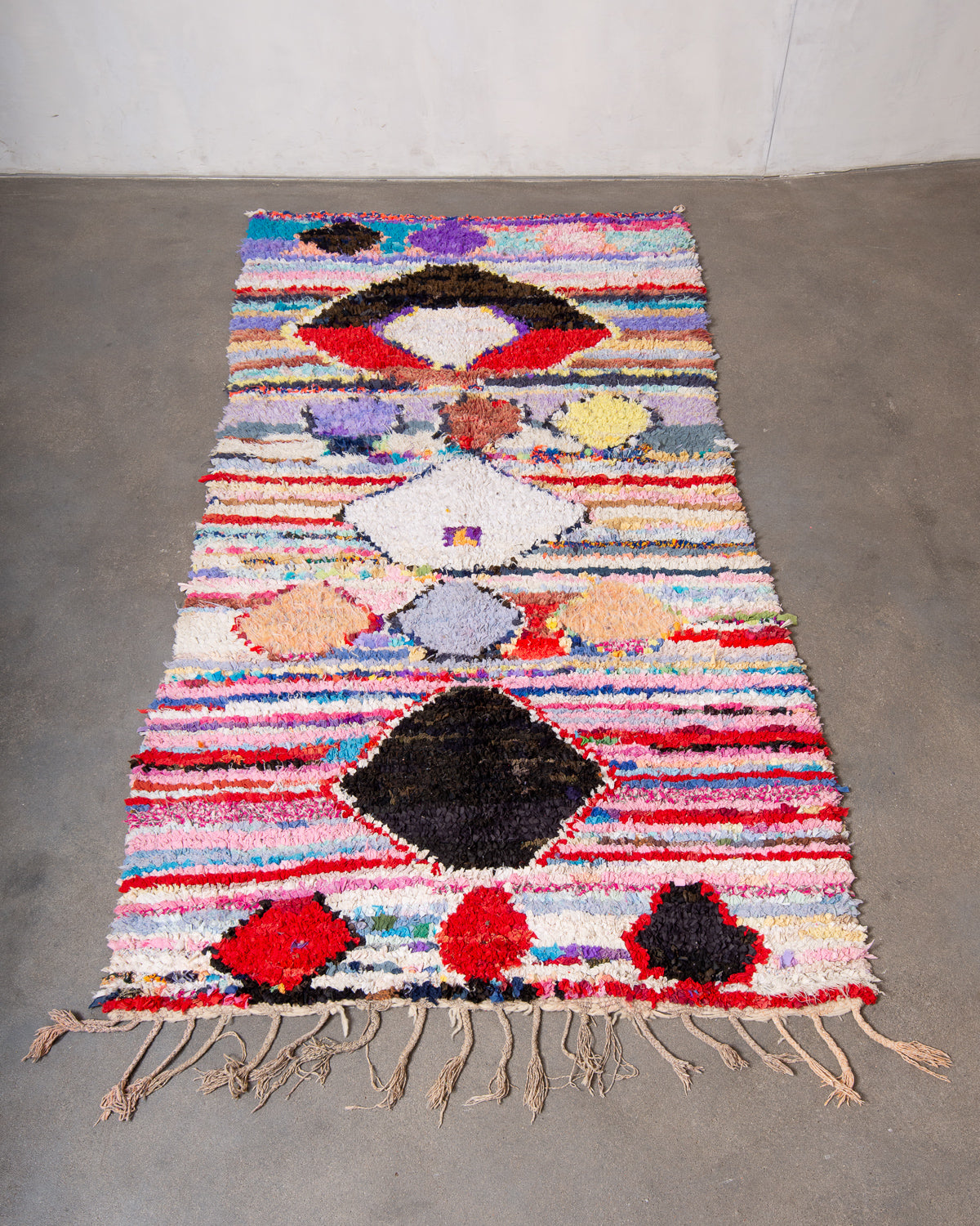 Modern designer vintage handcrafted Berber rug from Morocco. Boucherouite runner rug with beautiful colors and patterns.