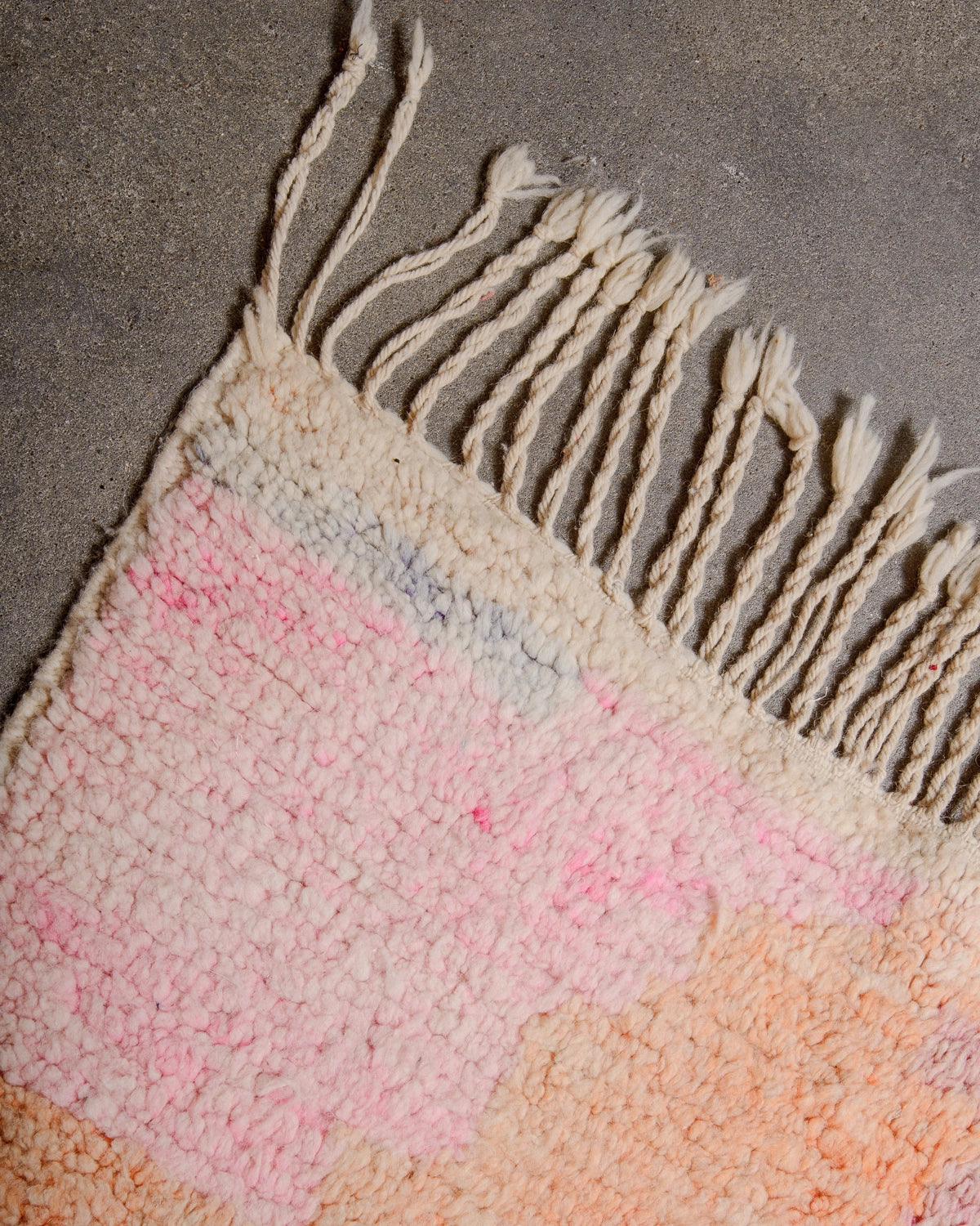 Natural wool tassels on Berberlin Vintage Berber Rug made of fluffy wool in pink, apricot and lavender.
