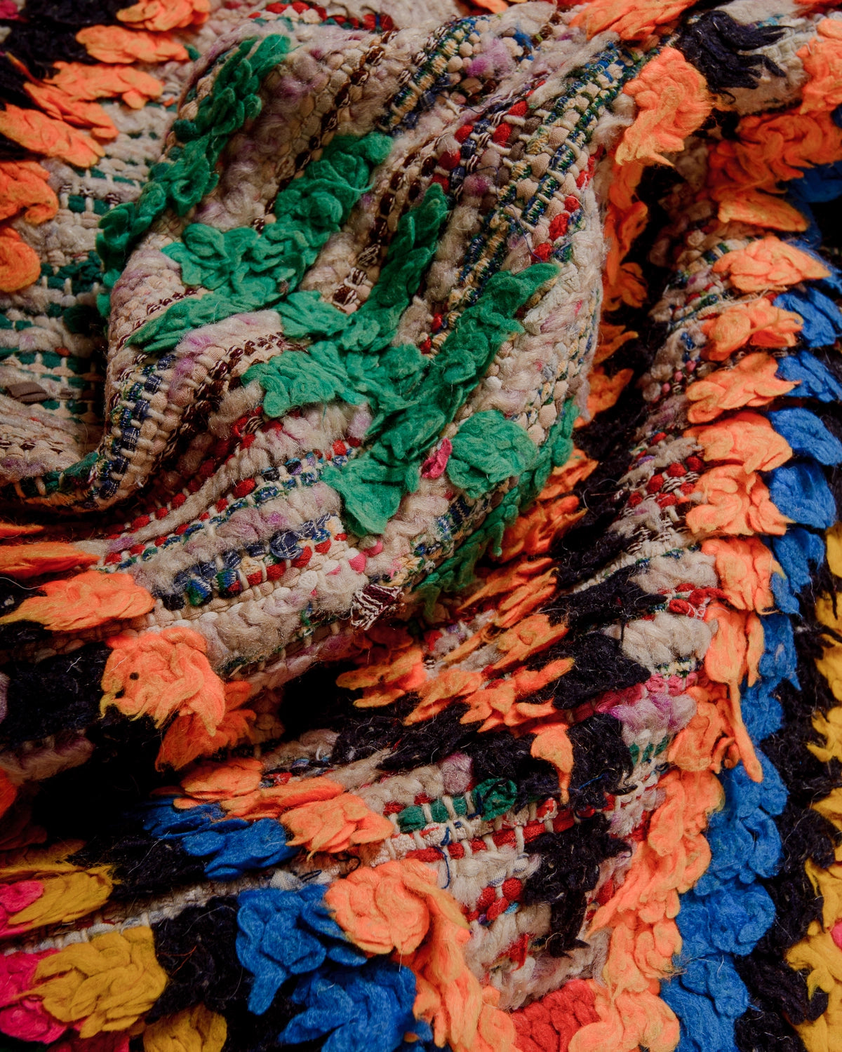 Detail of Berberlin Vintage Runner Rug in bright colours including neon orange and green. Made of recylced wool, yarn and cloth.