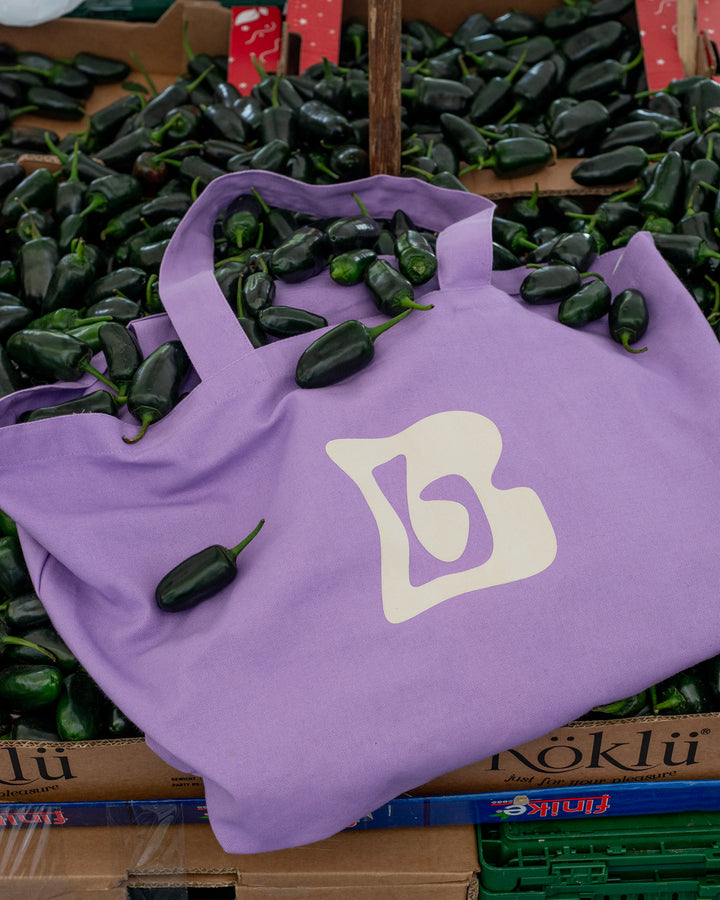 Lilac canvas tote bag with Berberlin logo in green and white.