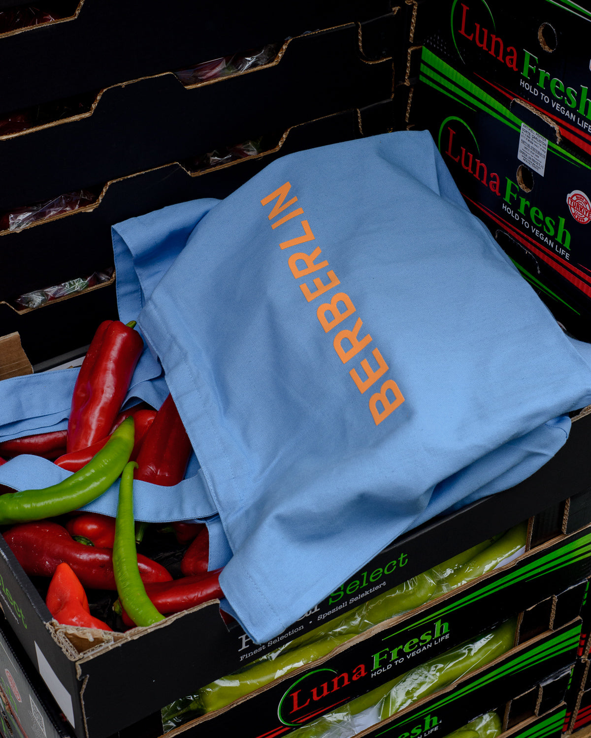 Blue canvas tote bag with Berberlin logo in orange and white.