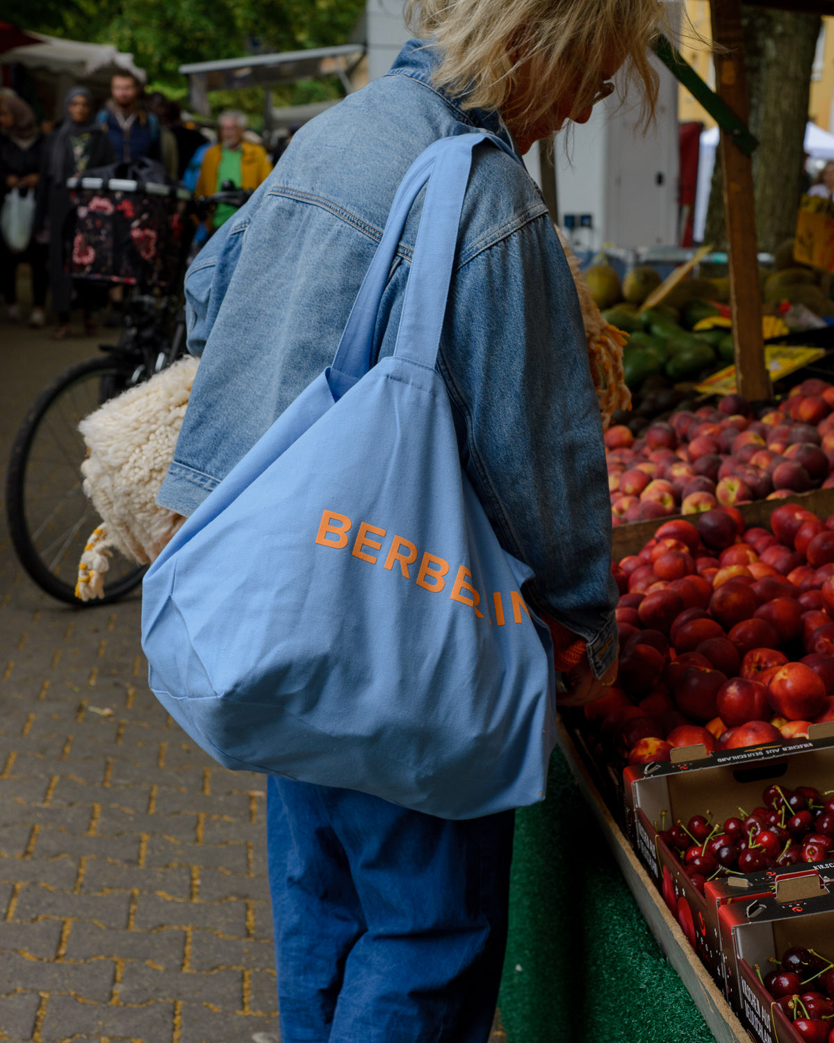 Blue canvas tote bag with Berberlin logo in orange and white.