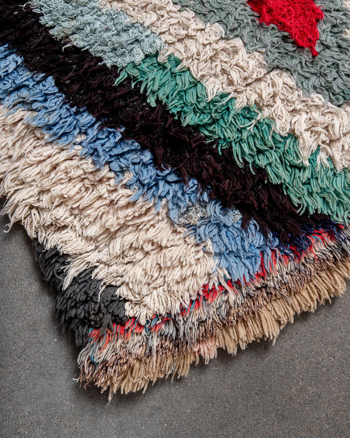 Modern designer vintage handcrafted Berber rug from Morocco. Boucherouite runner rug with beautiful colors and patterns.