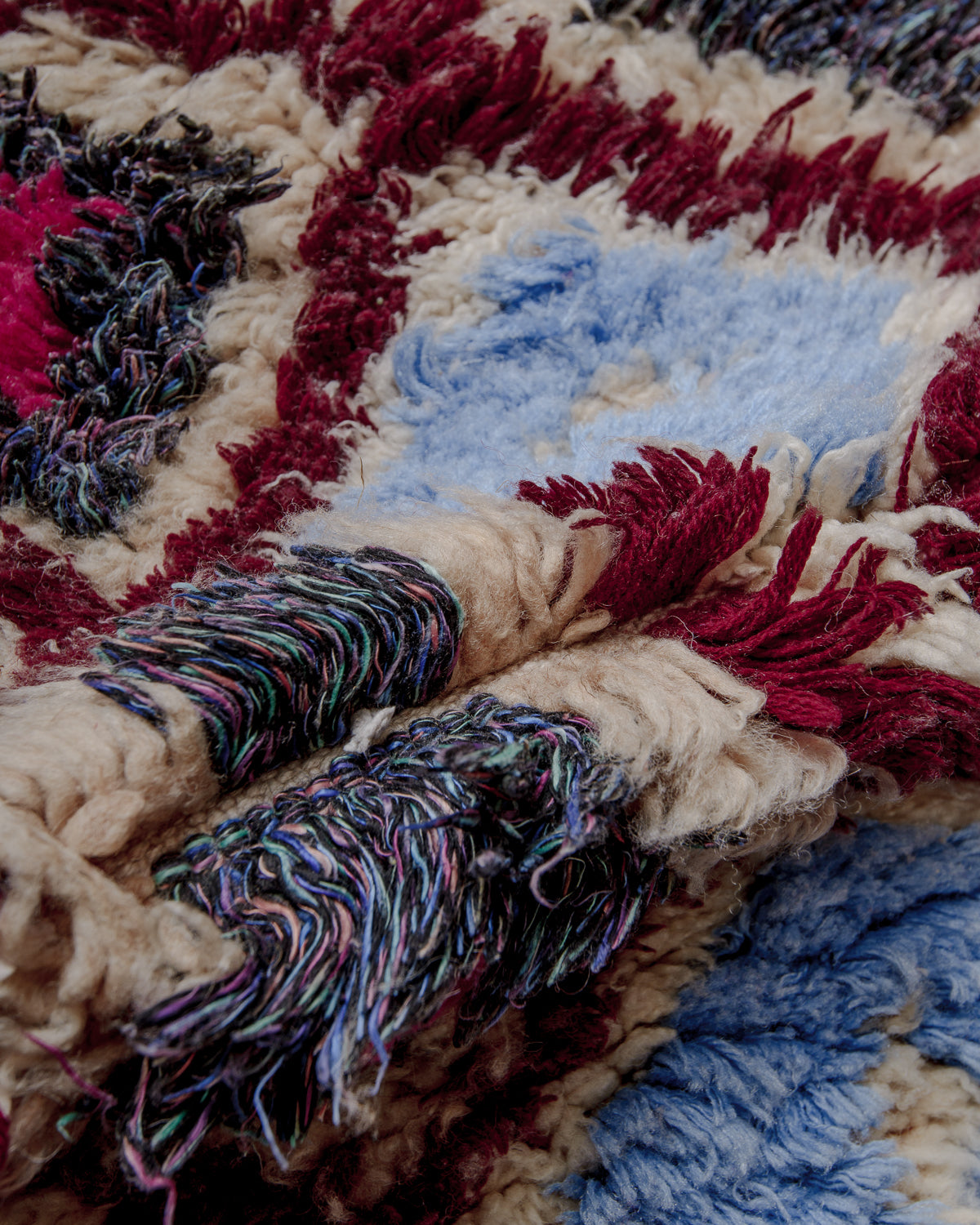 Close up of boucherouite rug with colourful cotton and thick wool pile.