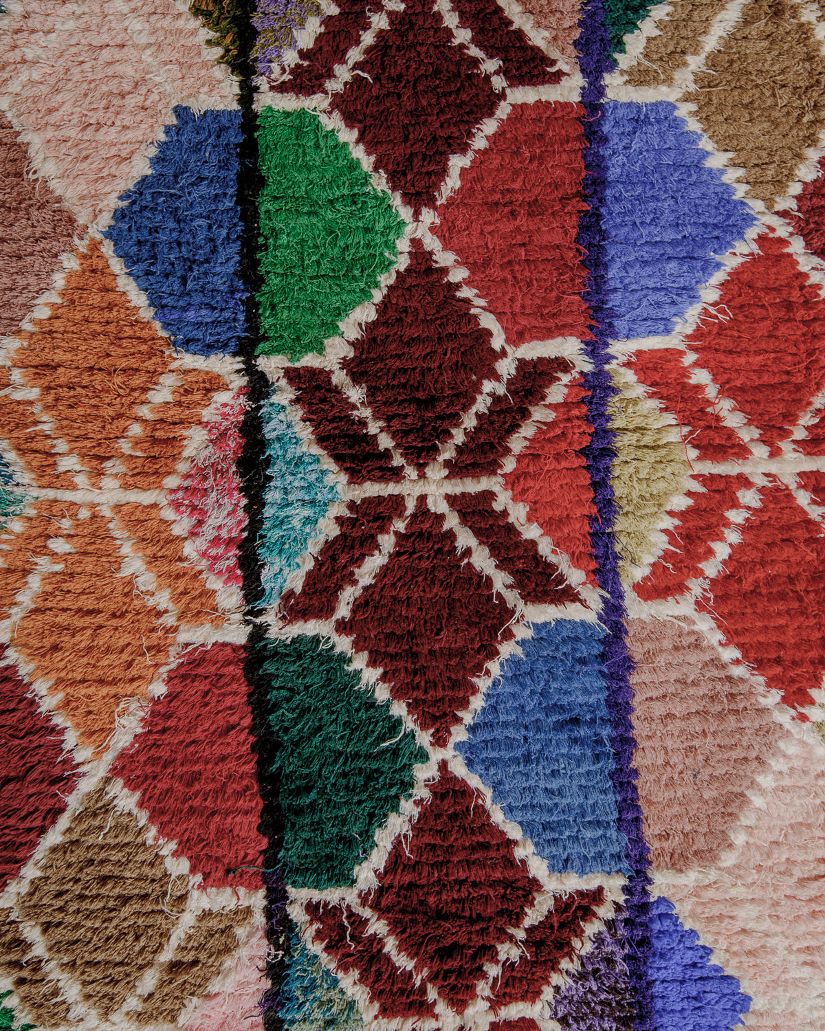 Close up of boucherouite rug surface with colourful cotton.