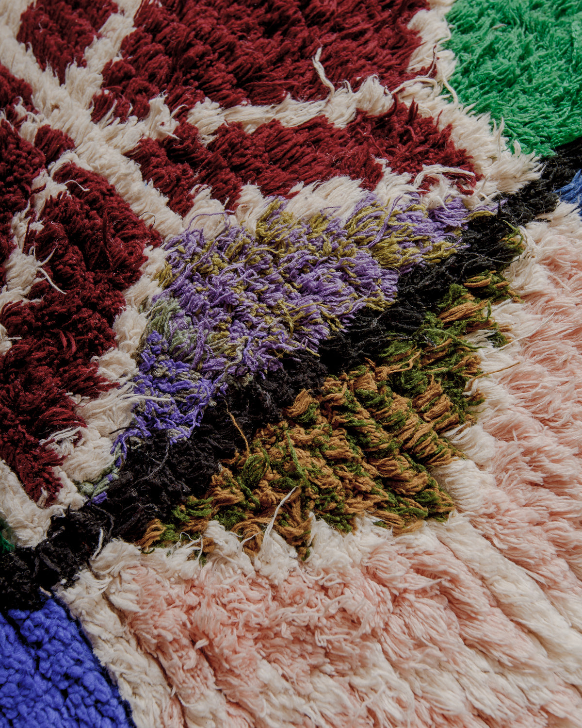 Close up of boucherouite rug surface with colourful cotton.