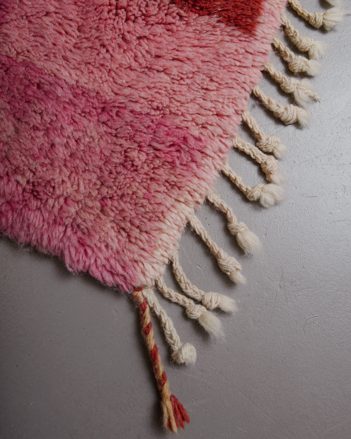 Corner of Berberlin rug with natural wool tassels.