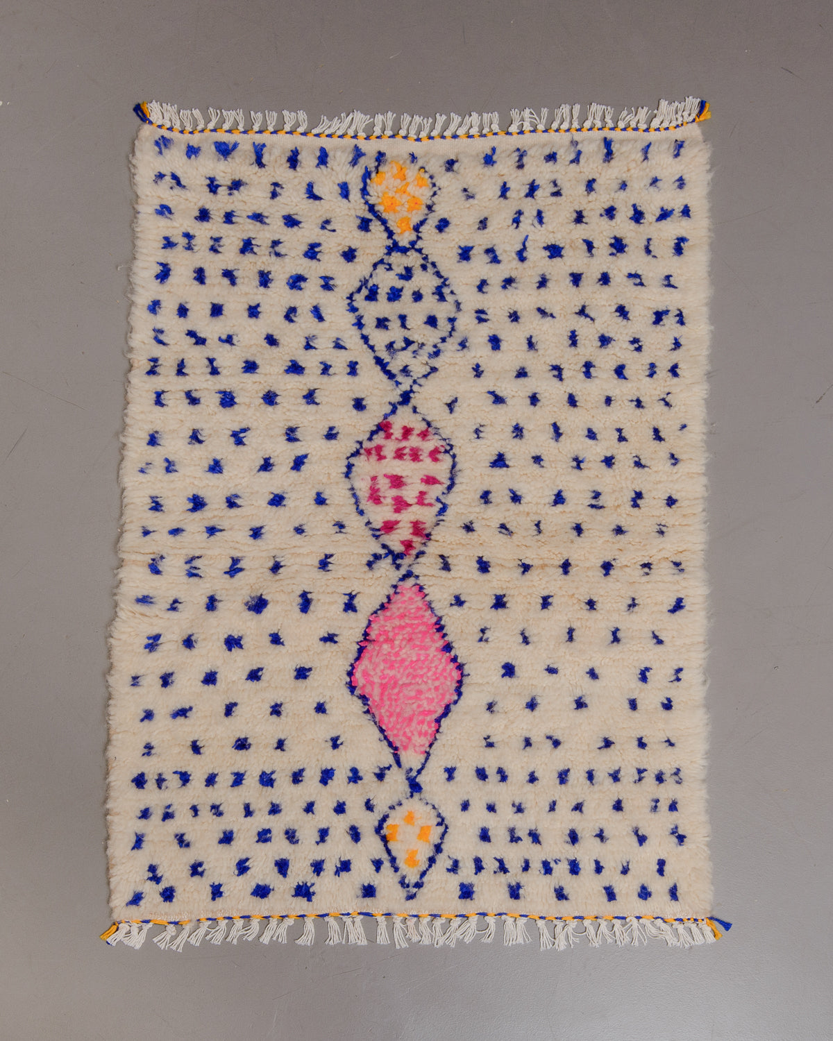 Small Berberlin Azilal rug on grey floor.
