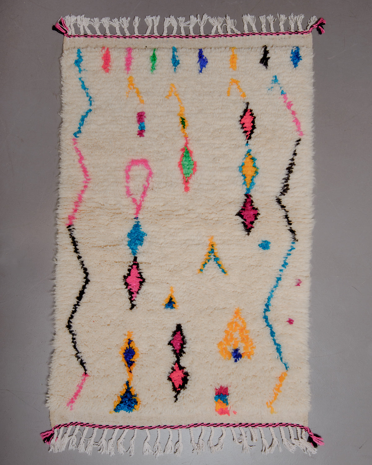 Small Berberlin Azilal rug on grey floor.
