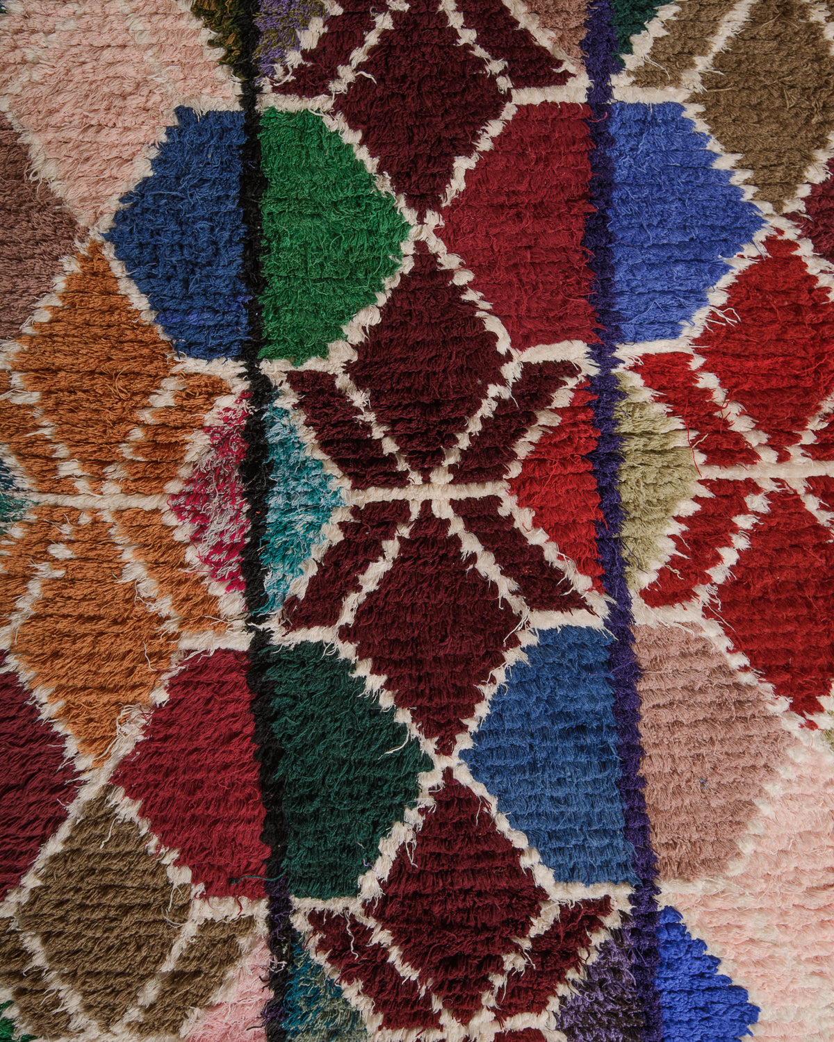 Close up of boucherouite rug surface with colourful cotton.
