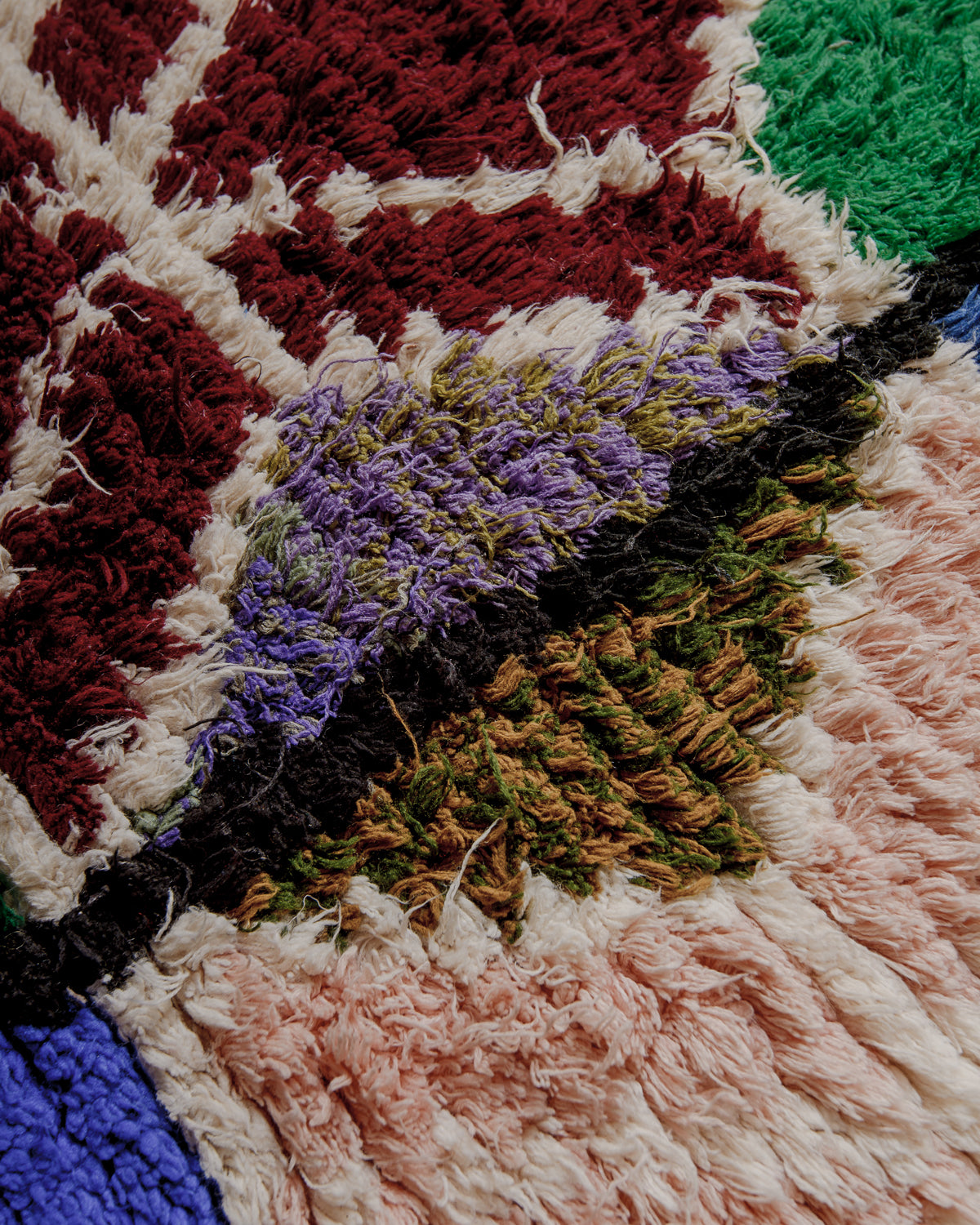 Close up of boucherouite rug surface with colourful cotton.